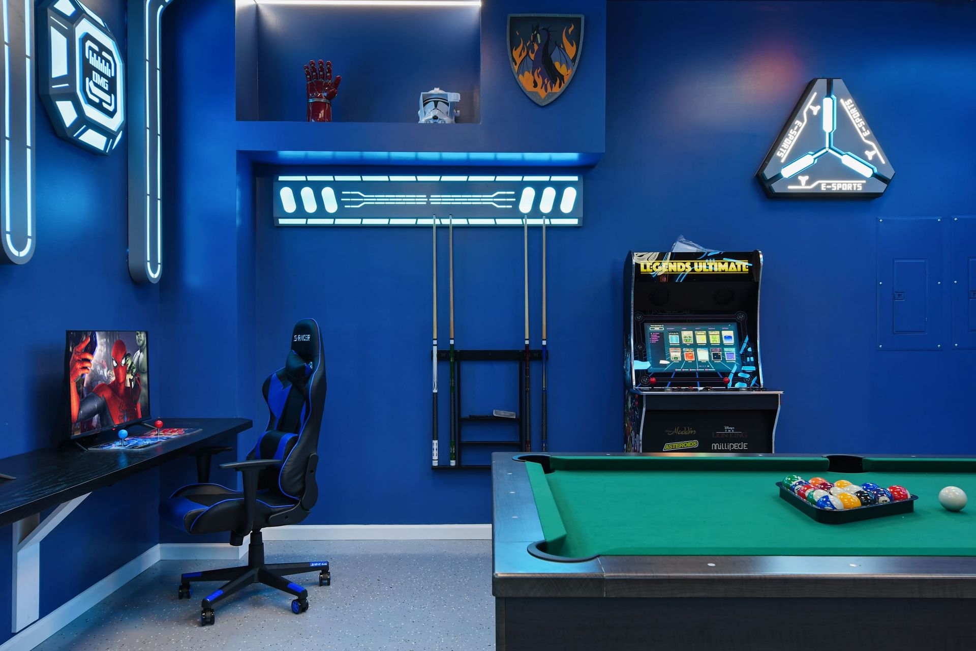 Futuristic game room with arcade, gaming setup, pool table, and sci-fi decor.