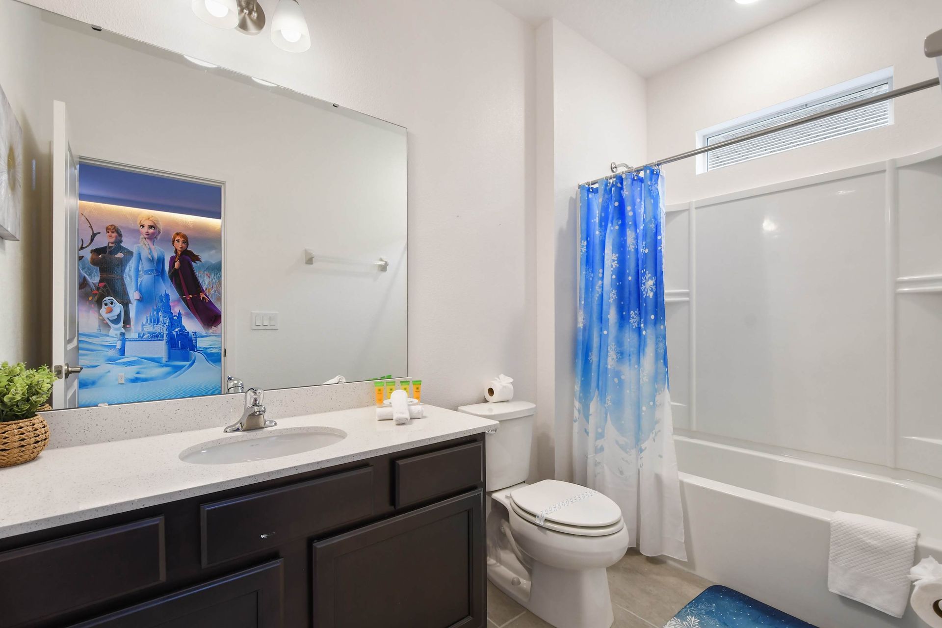 Bright double-sink bathroom with modern decor and a fun Star Wars touch!
