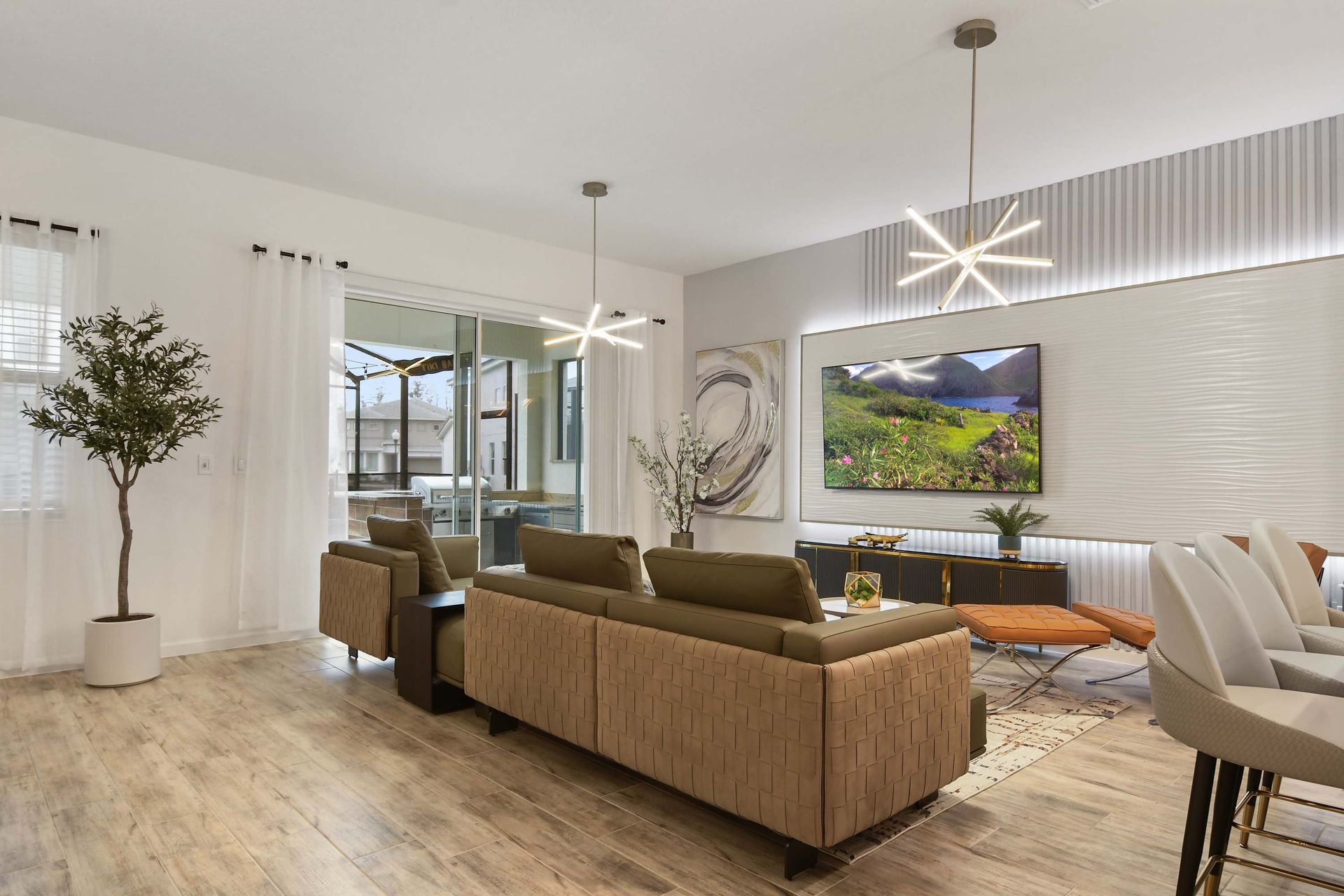 Modern open-concept living space with stylish decor, sleek lighting, and patio access.