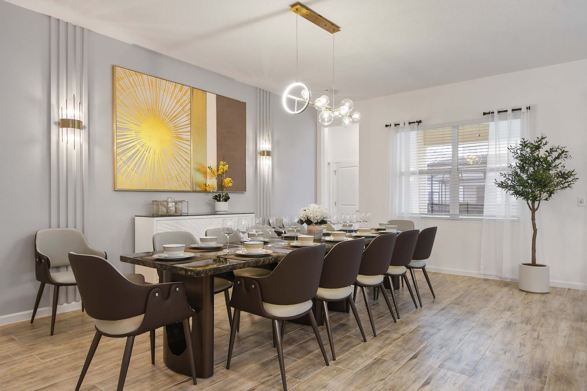 Sophisticated dining space with modern lighting, elegant decor, and seating for twelve.