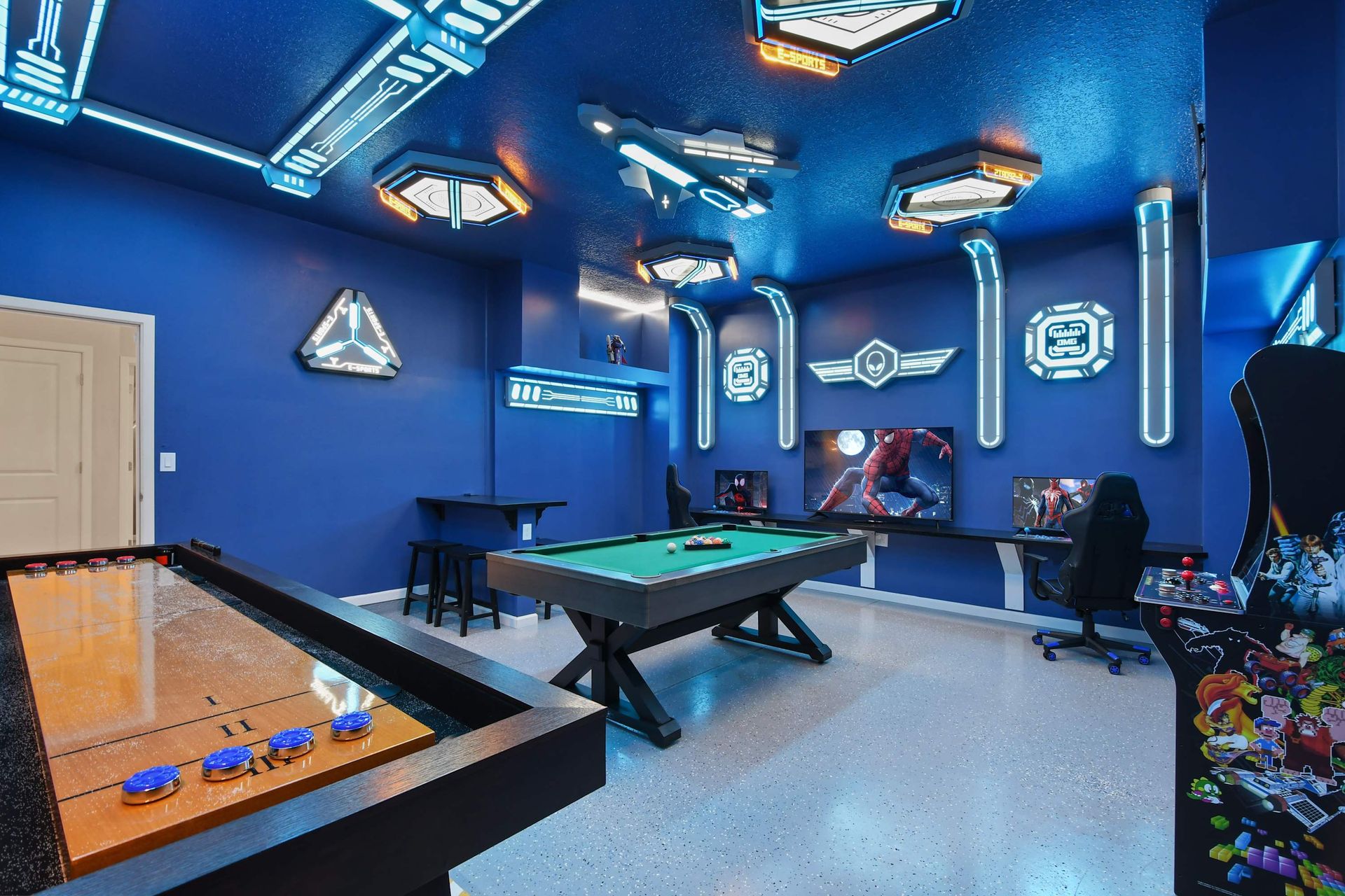 Epic sci-fi game room with arcade, gaming setup, pool table, and futuristic lighting.