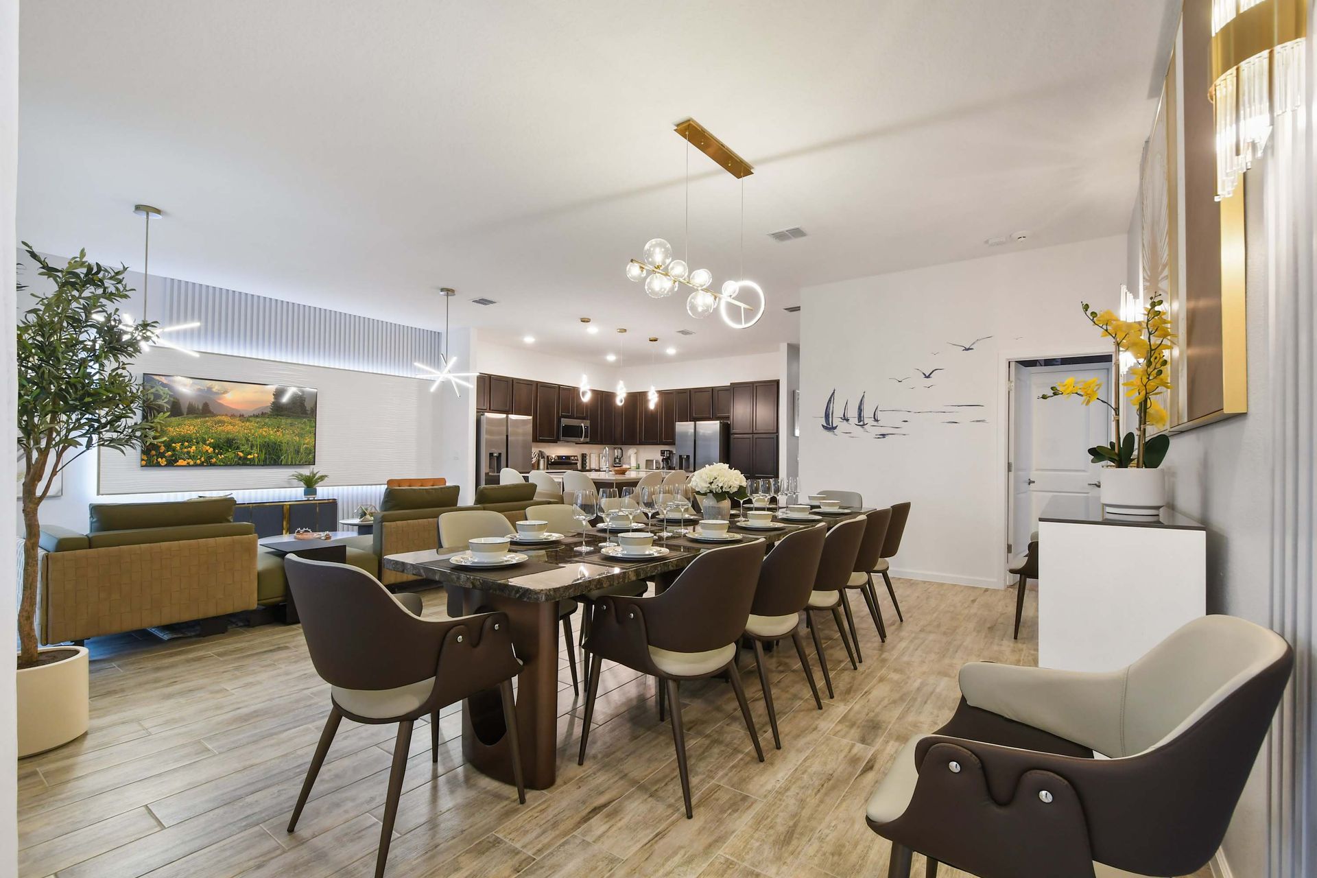 Spacious open-concept dining and living area with modern decor and elegant lighting.