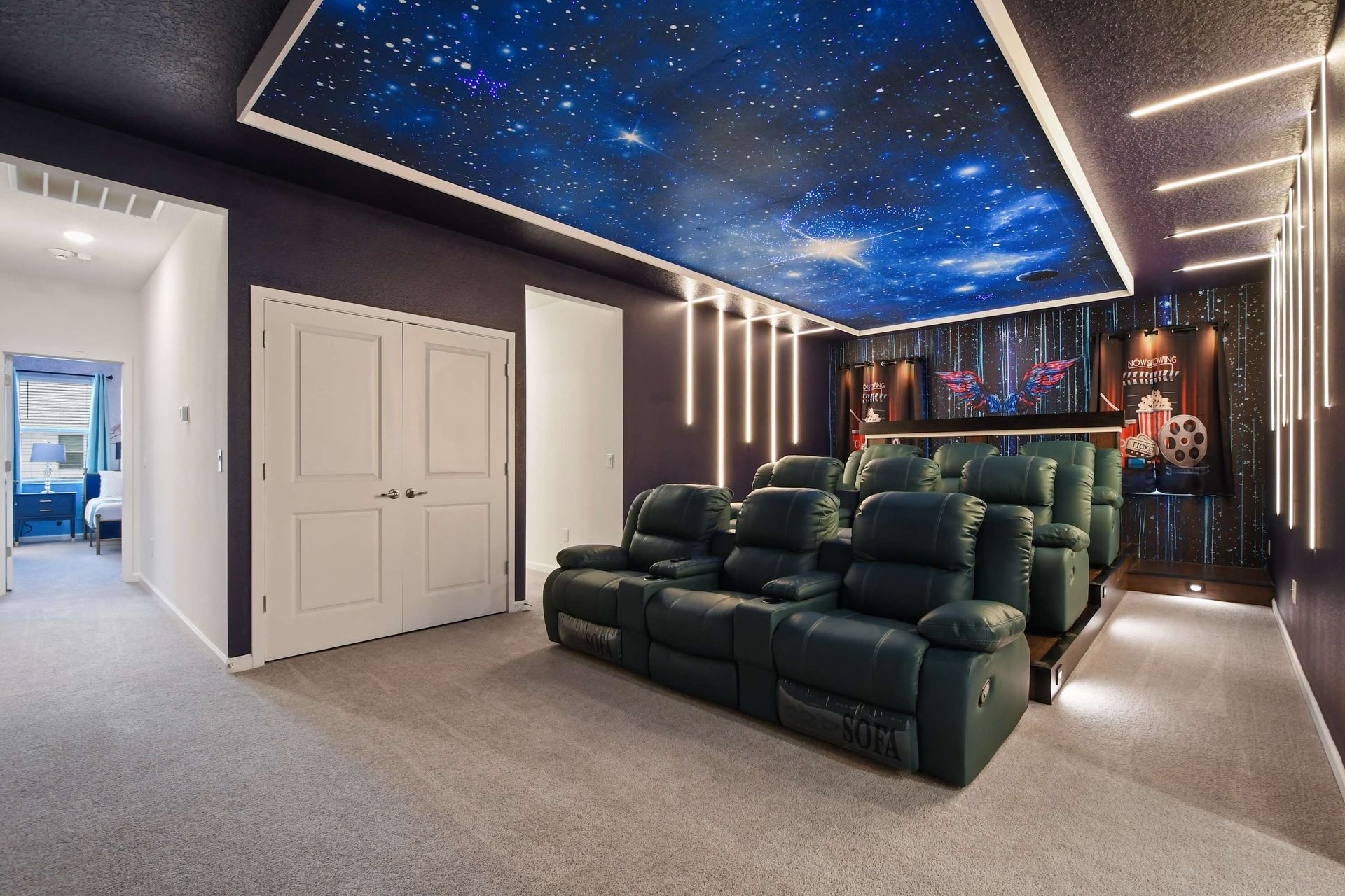 Luxury home theater with reclining seats, starry ceiling, and immersive lighting design.