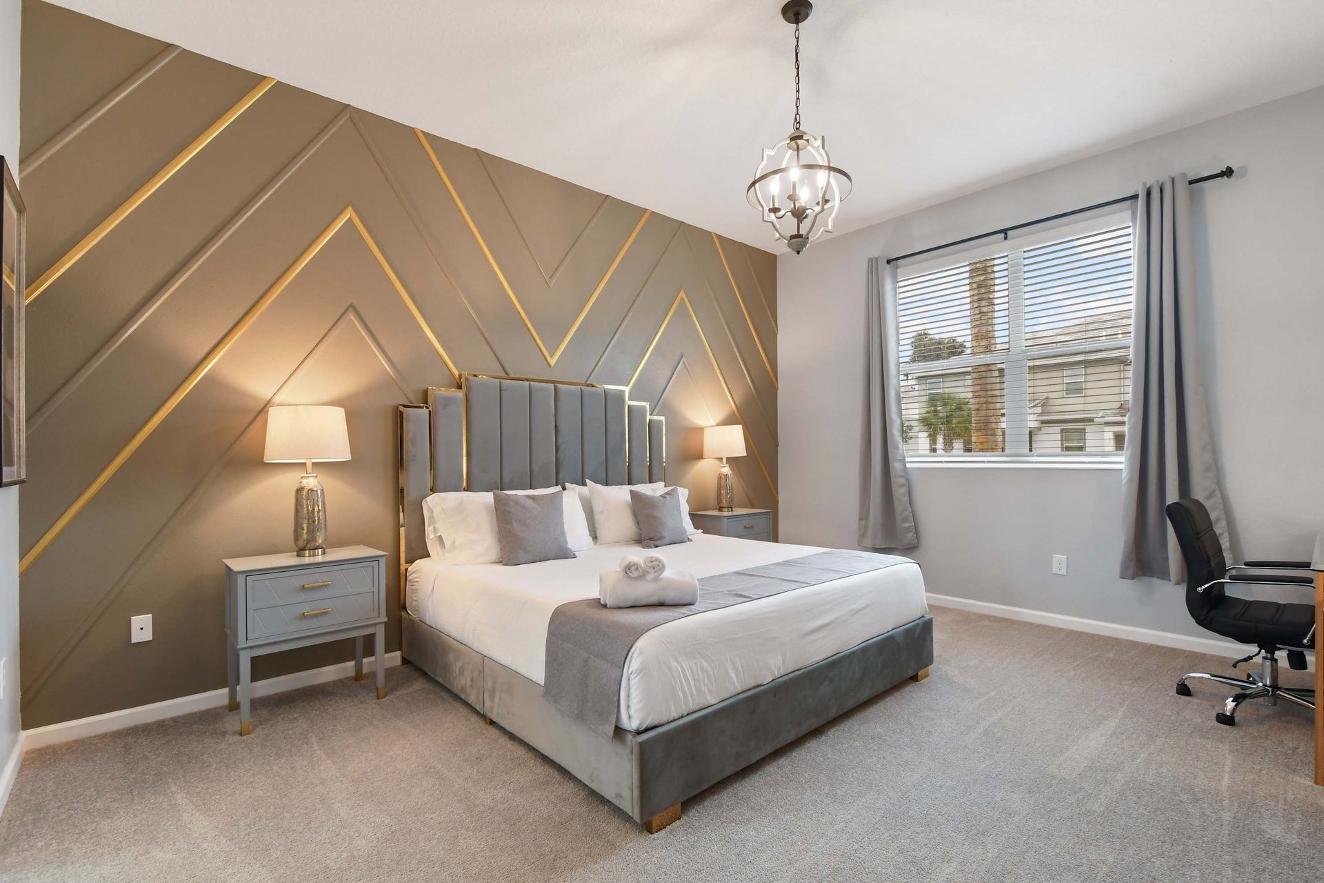 Luxurious master bedroom with elegant decor, plush bedding, and a stylish accent wall.