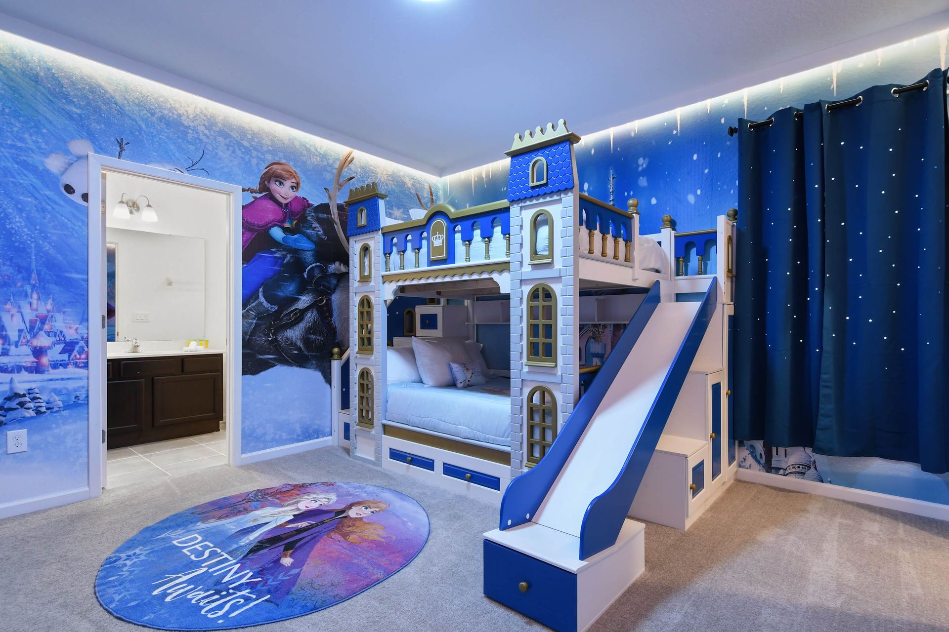 Enchanting Frozen-themed bedroom with a castle bunk bed, slide, and magical lighting.