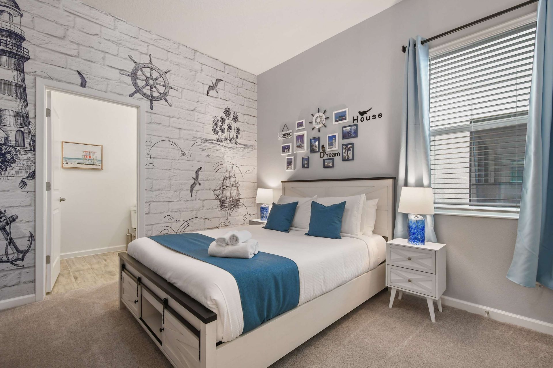 Cozy nautical-themed bedroom with ocean-inspired decor, soft blues, and warm lighting.