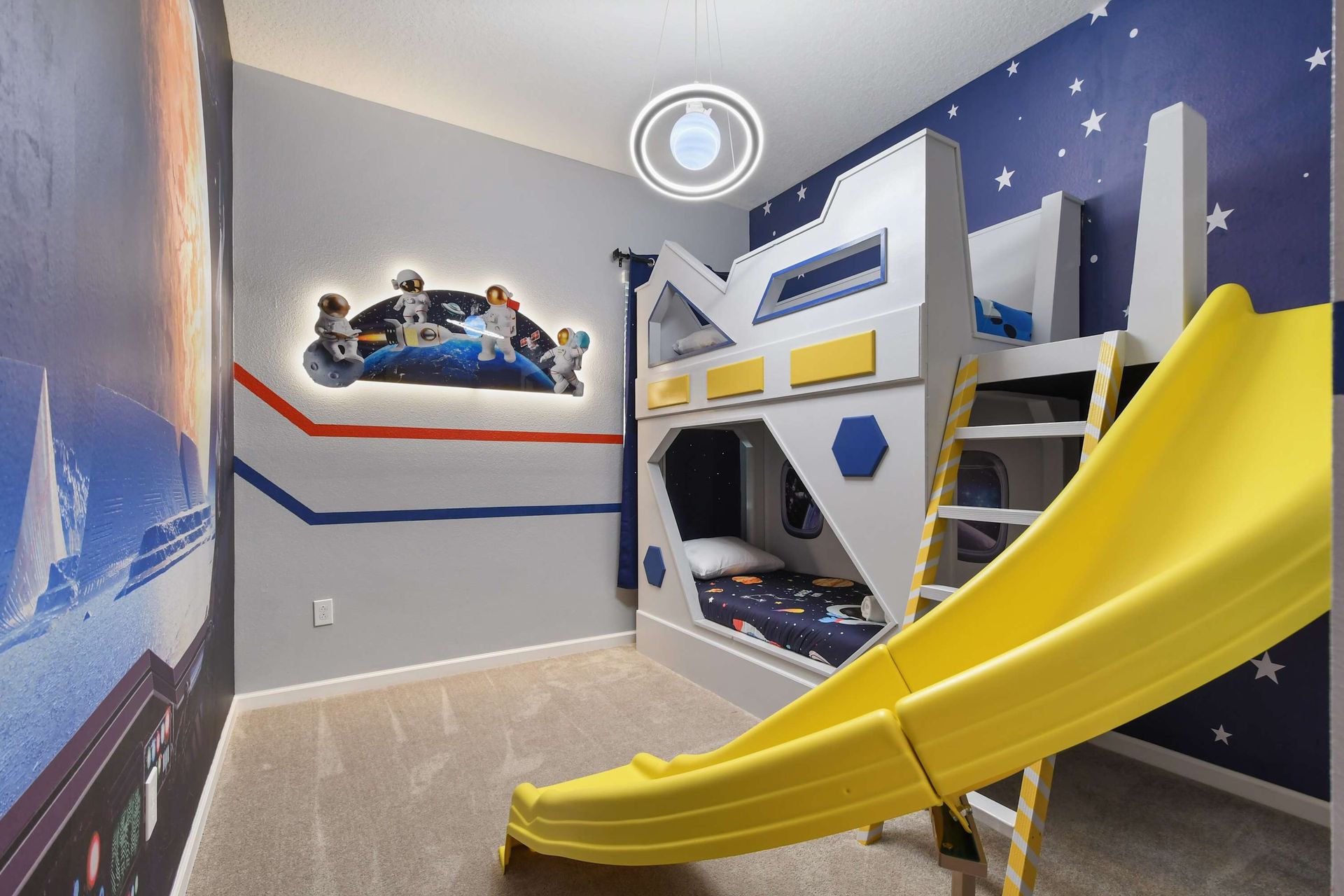 Space-themed kids' bedroom with a custom bunk bed, slide, and galactic decor.