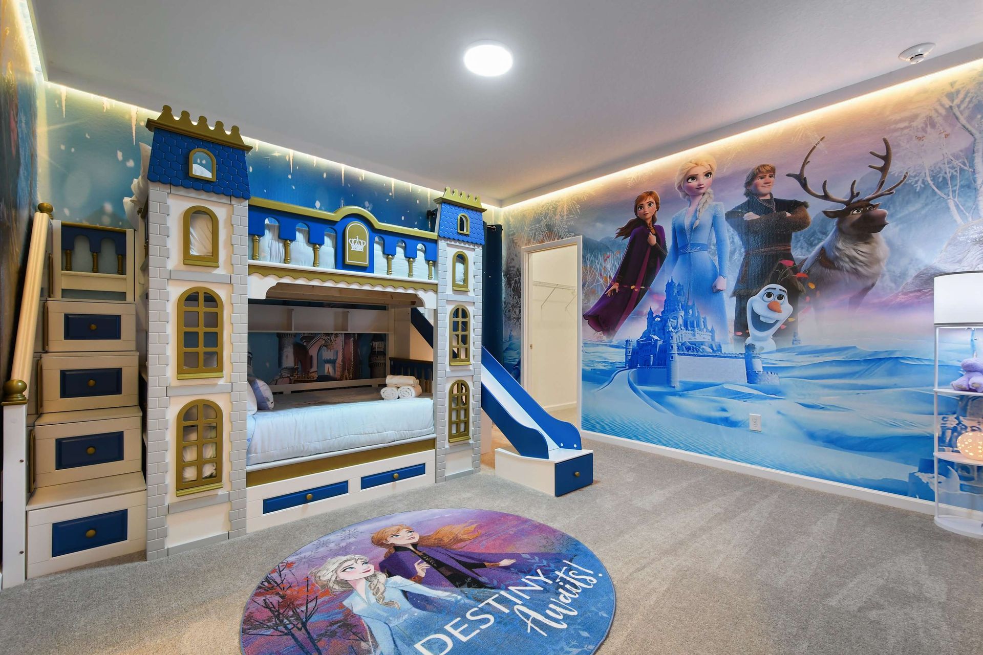 Frozen-inspired princess bedroom with a castle bunk bed, slide, and magical decor.