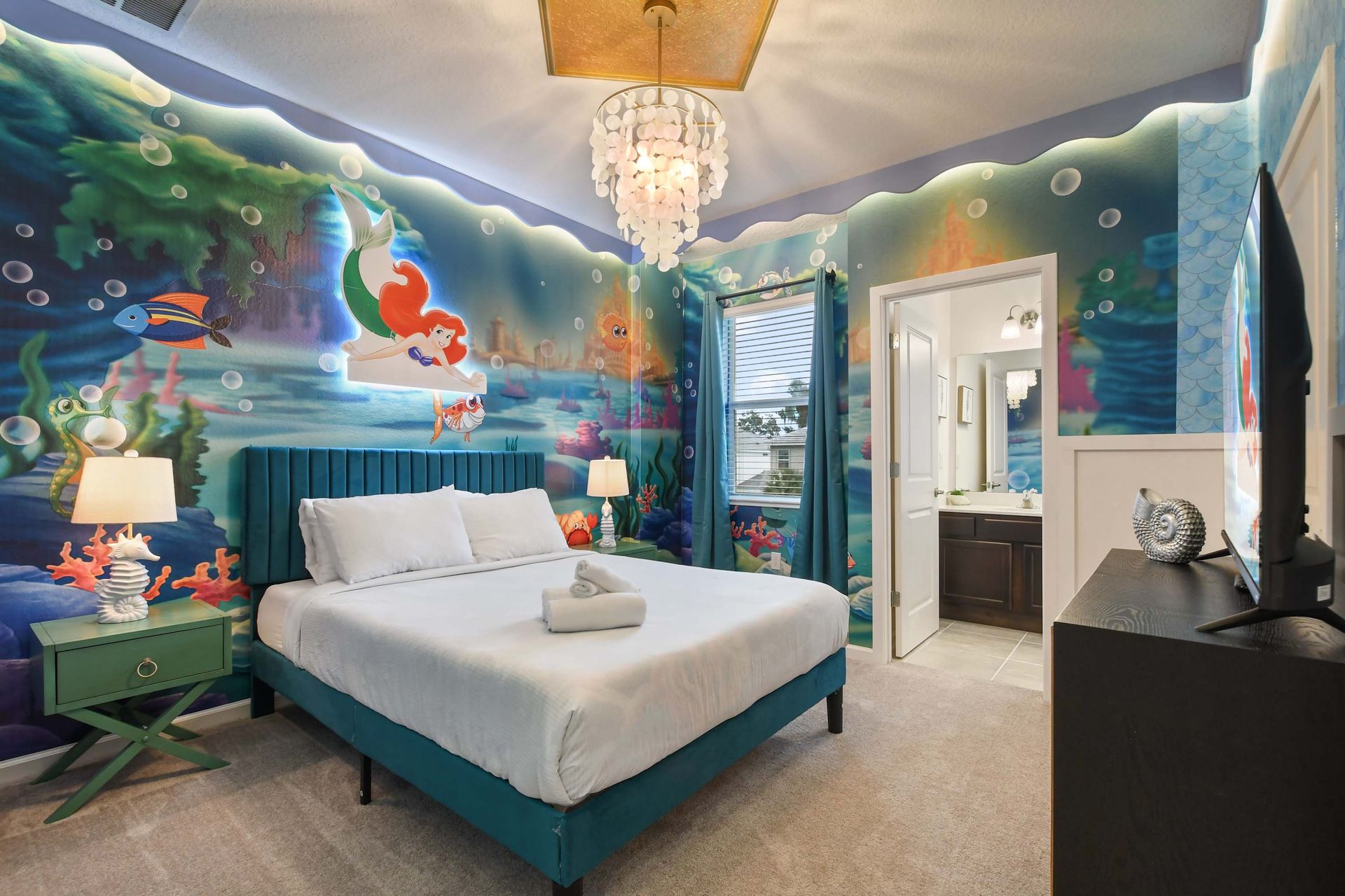 Under-the-sea themed bedroom with ocean murals, seashell decor, and cozy lighting.