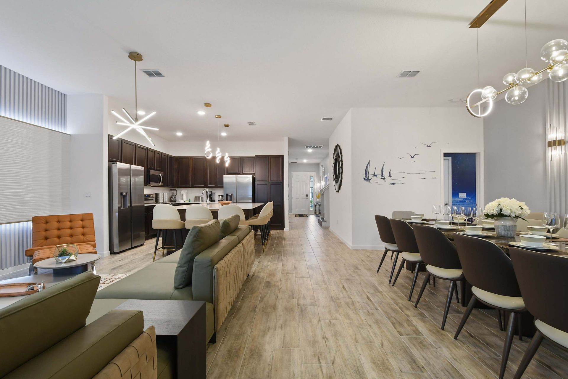 Stylish open-concept home with a modern kitchen, elegant dining area, and cozy lounge.