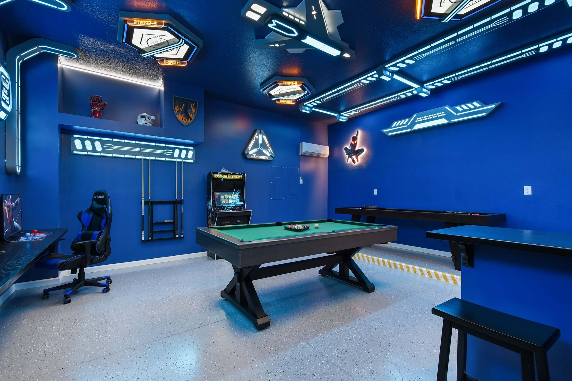 Epic sci-fi game room with arcade, gaming setup, pool table, and futuristic lighting.