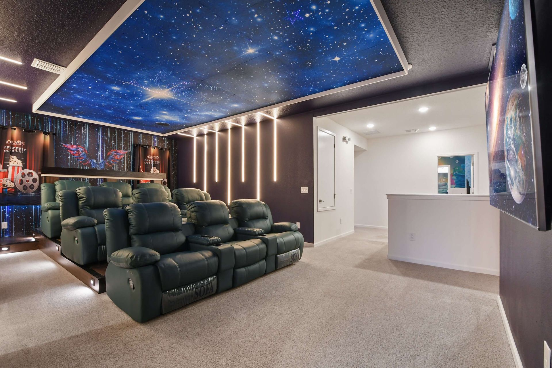 Luxury home theater with reclining seats, starry ceiling, and immersive lighting design.