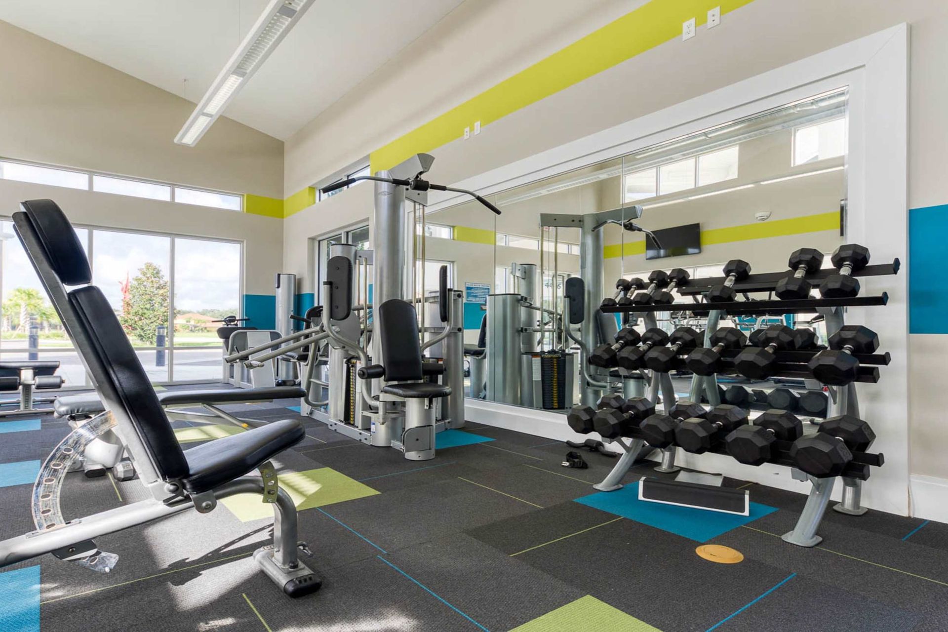Stay fit in a modern gym with top-tier equipment, bright decor, and pool views