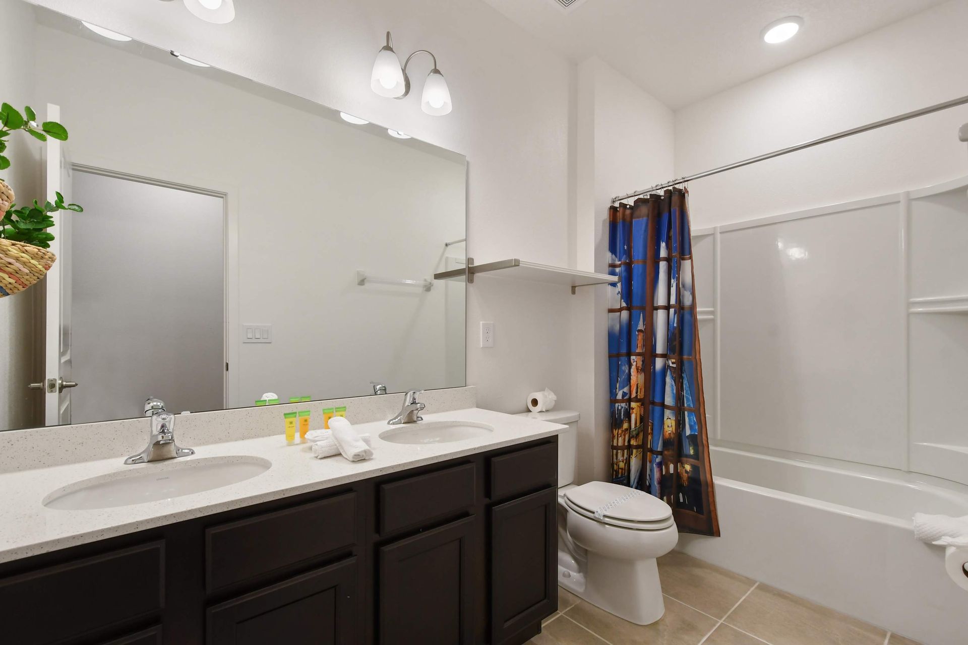 Spacious master bathroom with dual sinks, a glass-enclosed shower, and modern touches!