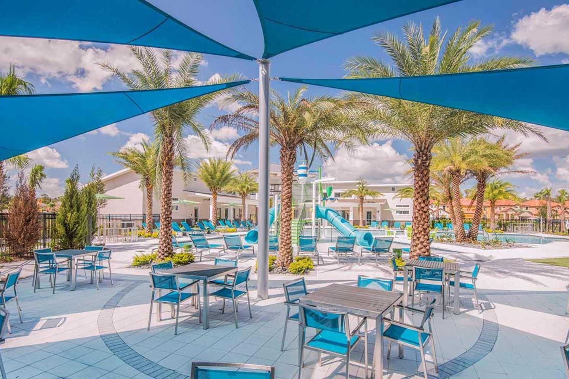 Resort-style retreat with shaded seating, a water park, and a sparkling pool