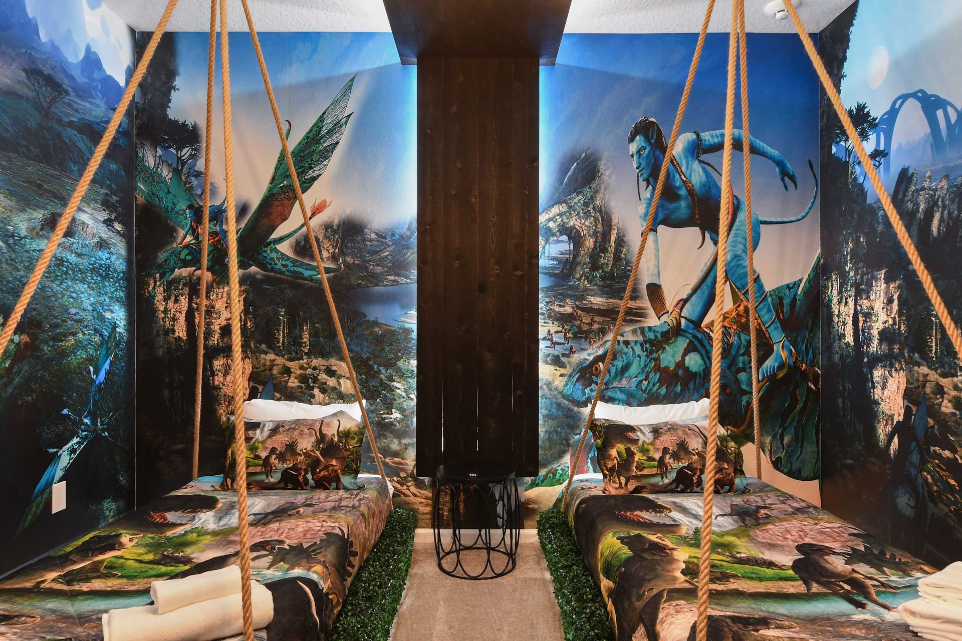 Immersive fantasy-themed bedroom with hanging beds, lush decor, and epic wall murals.