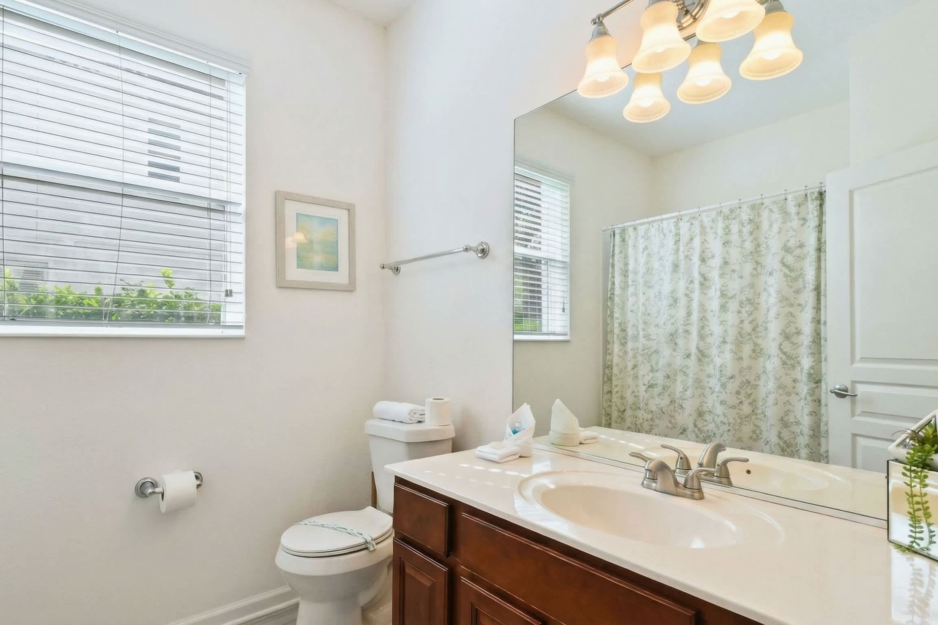 Bright and stylish bathroom with a dual vanity, elegant decor, and plenty of natural light.