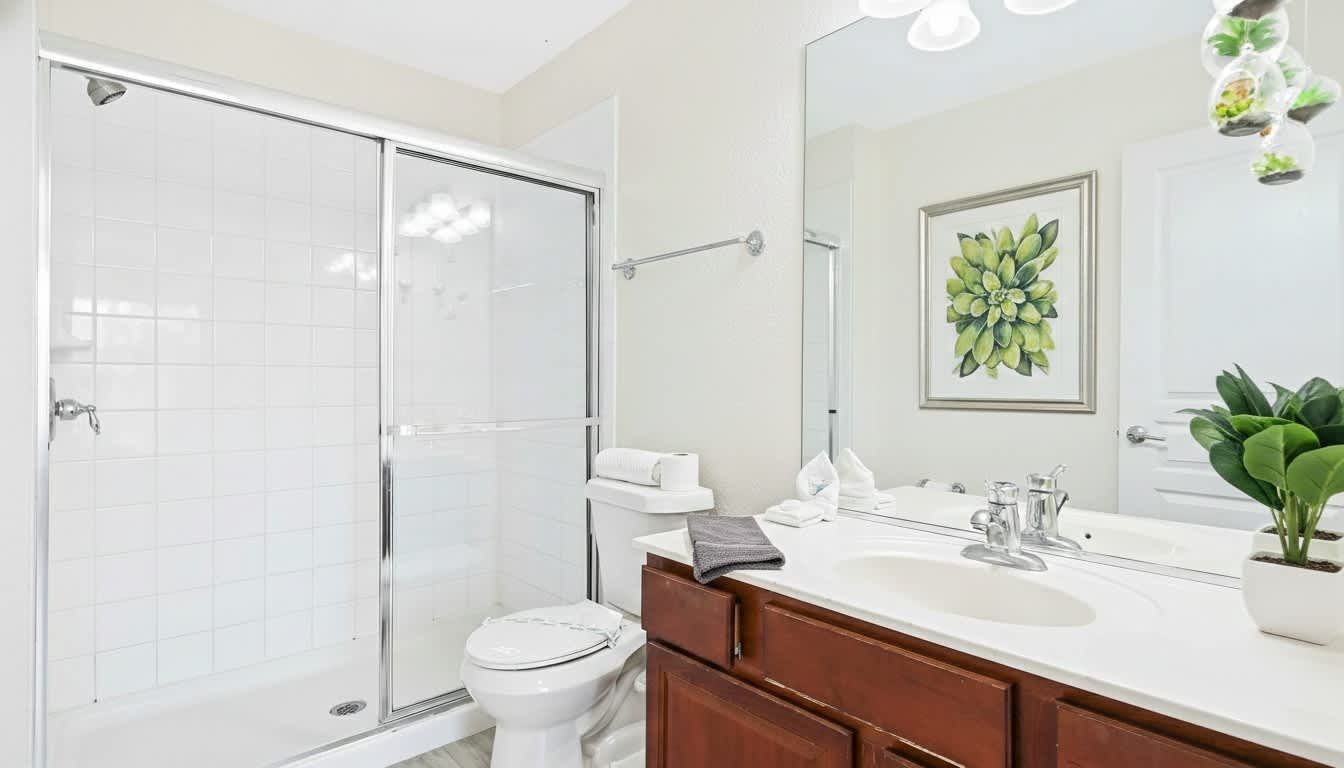 Spacious and bright bathroom with a soaking tub, glass shower, and elegant decor.