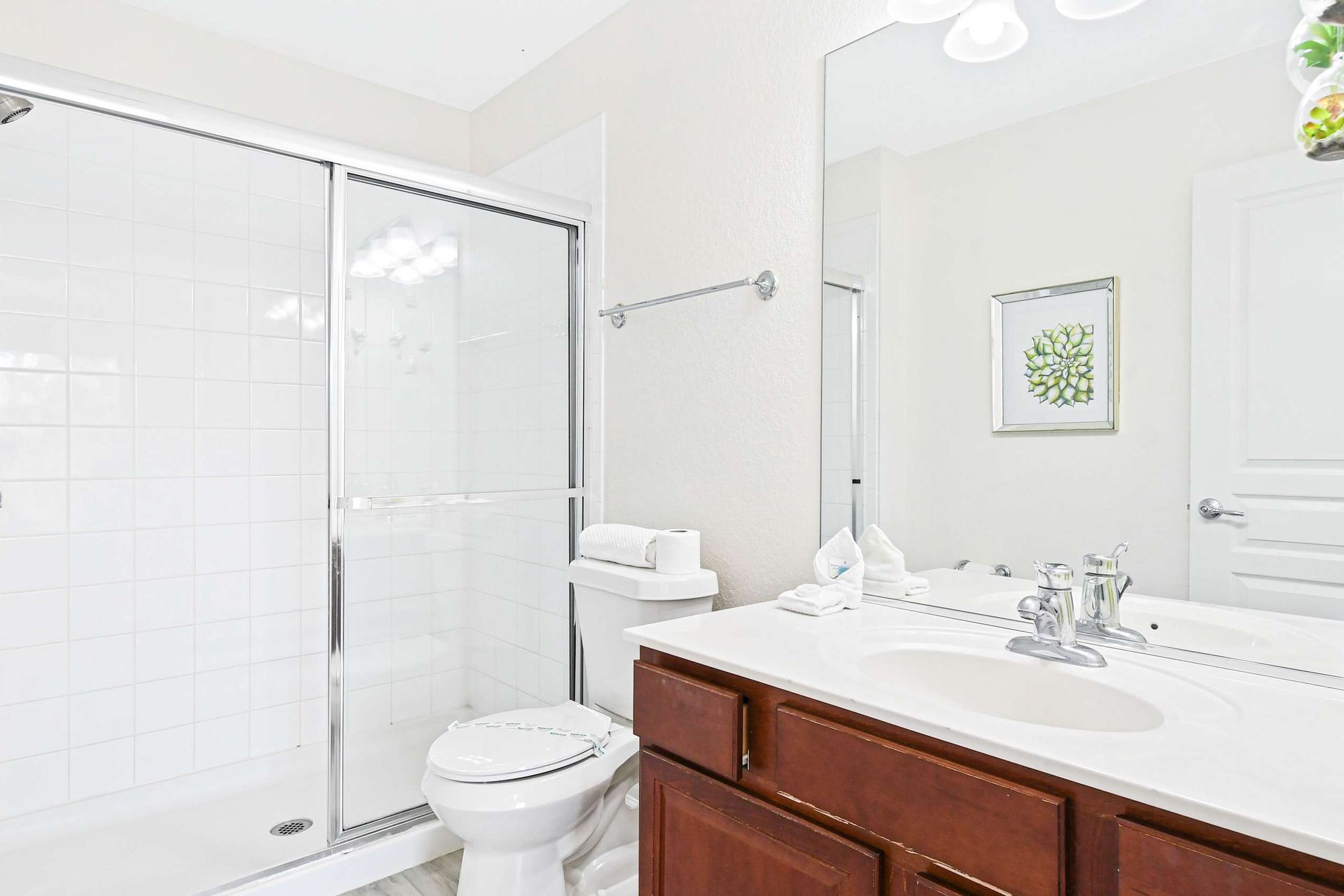 Spacious and bright bathroom with a soaking tub, glass shower, and elegant decor.
