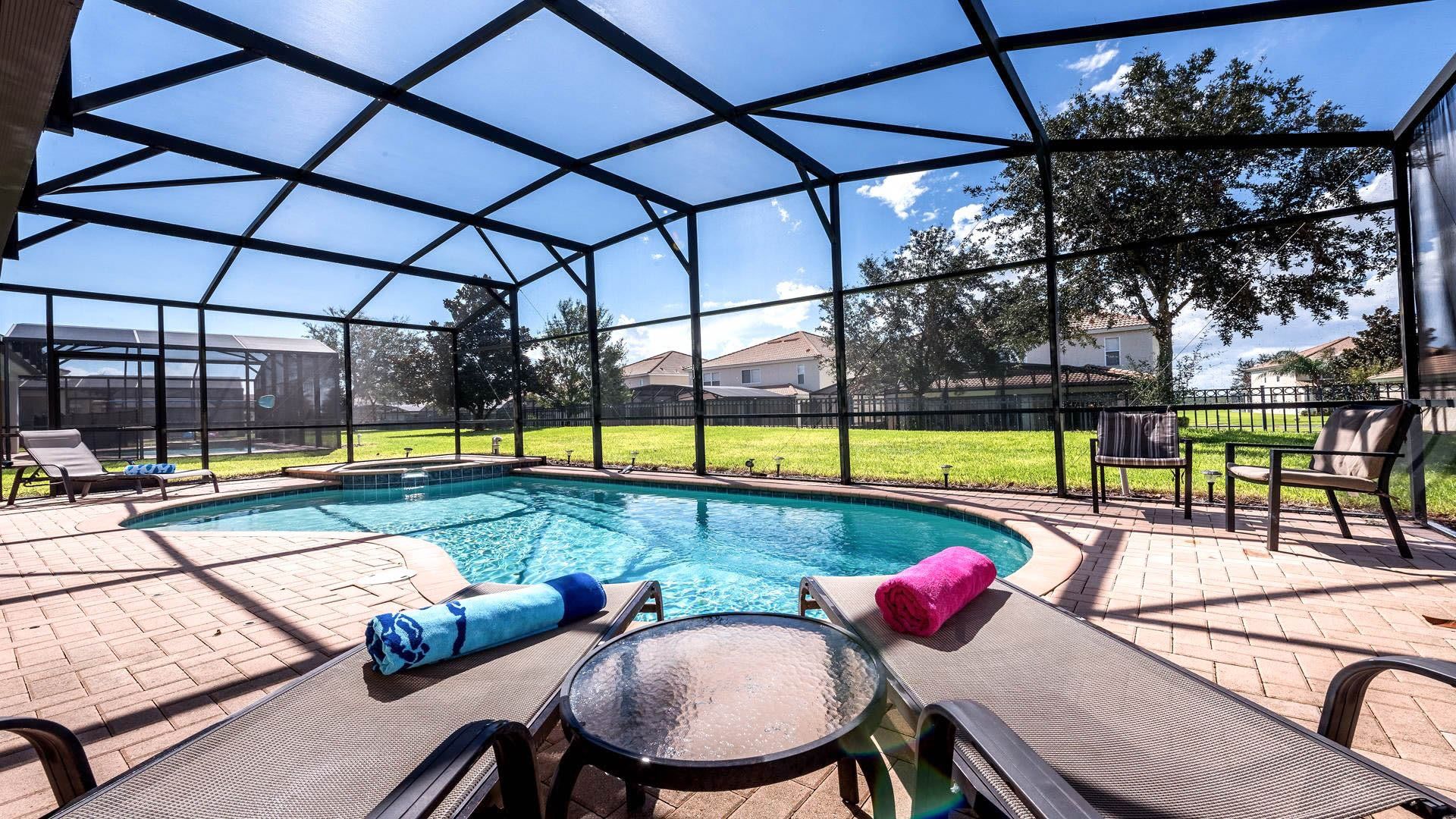 Relaxing screened-in pool area with lounge chairs, sunny views, and total privacy.