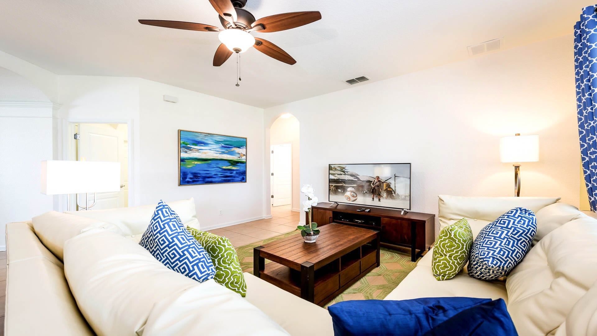 Bright and cozy living room with plush seating, modern decor, and entertainment setup.