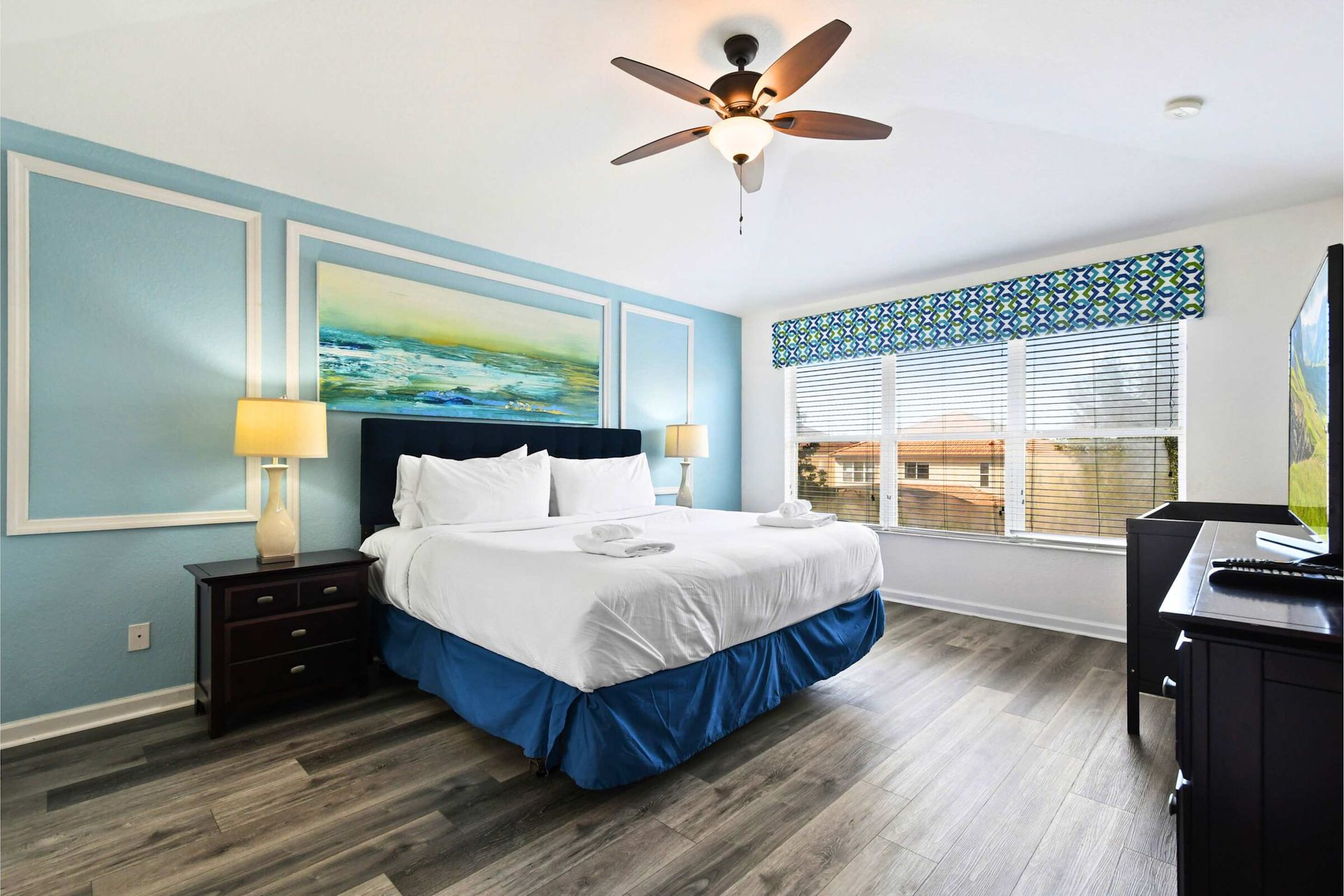 Spacious and serene bedroom with a plush king bed, modern decor, and natural light.