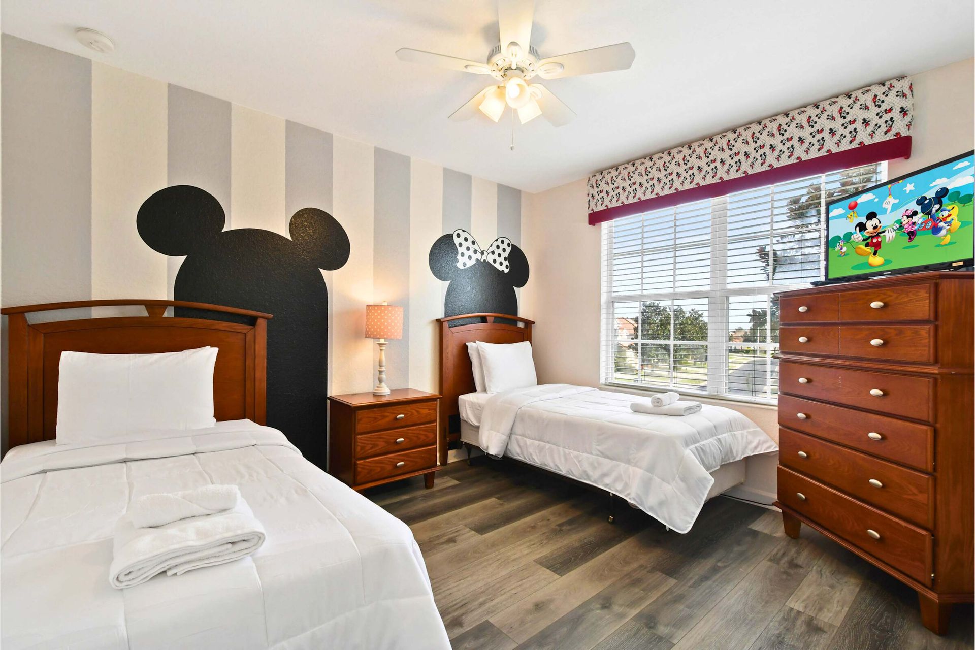 Whimsical Mickey and Minnie-themed bedroom with cozy twin beds and fun decor.