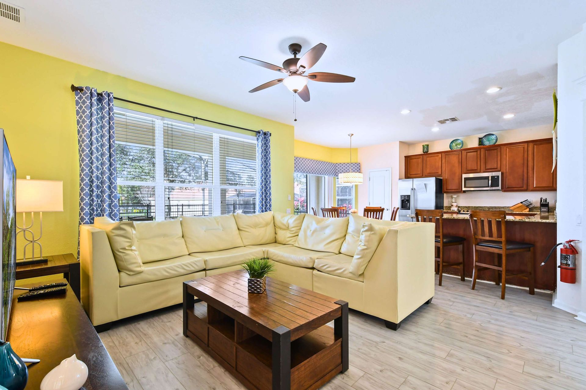 Spacious open-concept living area with cozy seating, natural light, and modern decor.