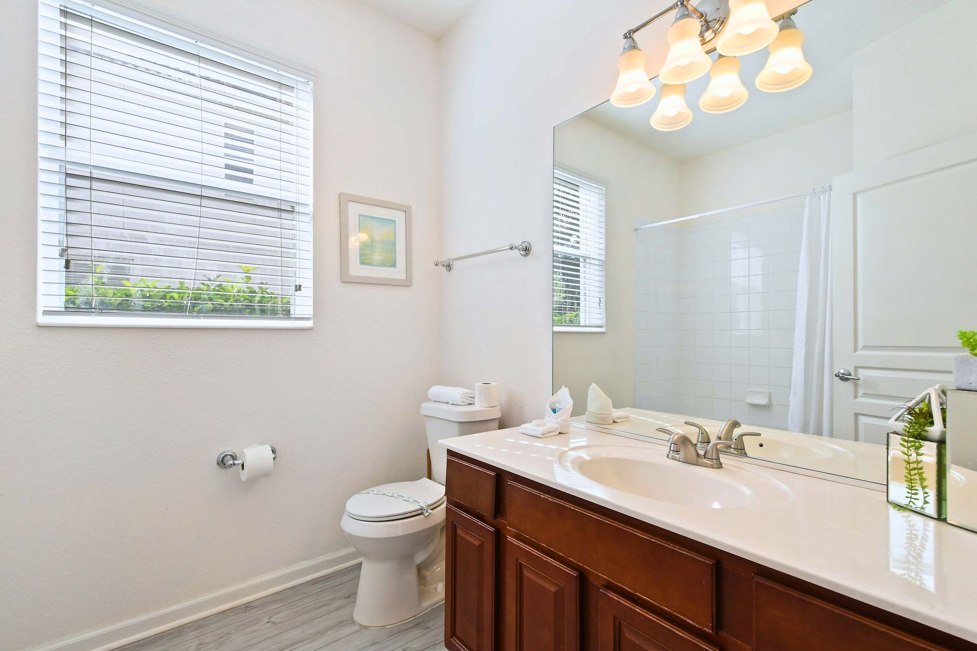Bright and stylish bathroom with a dual vanity, elegant decor, and plenty of natural light.
