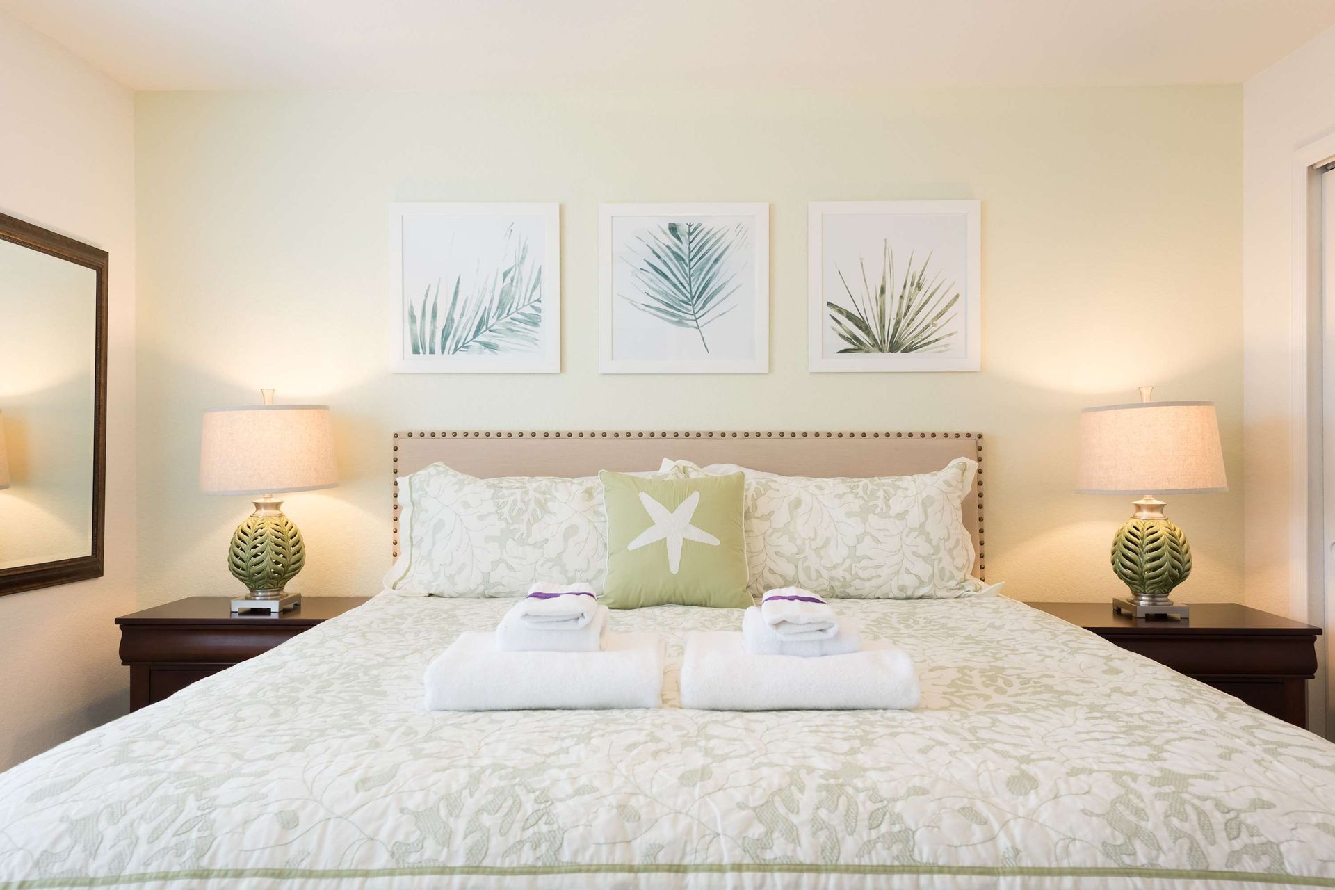 Tranquil coastal-themed bedroom with a plush king bed, soft tones, and elegant decor.