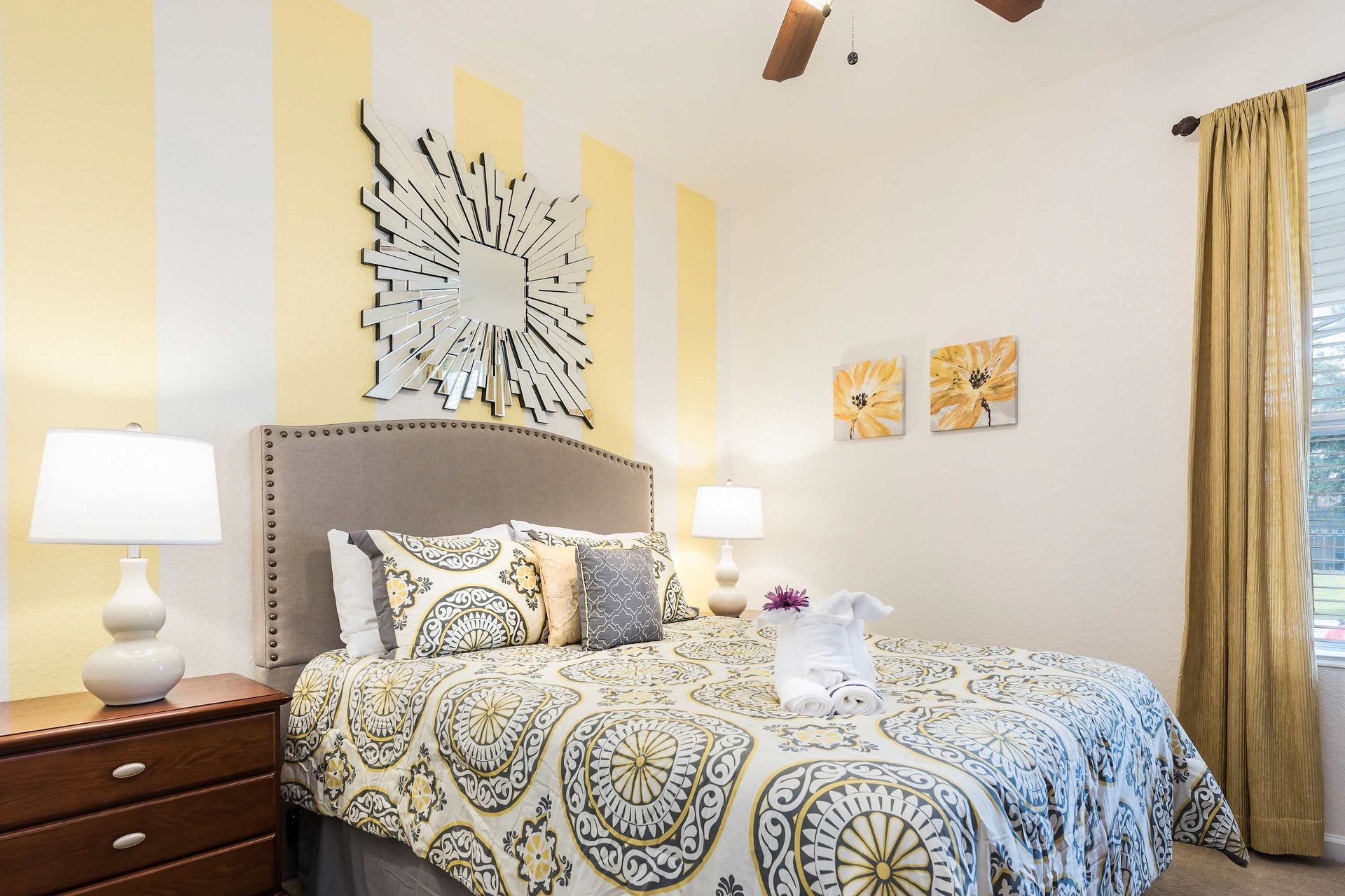 Bright and cheerful bedroom with a plush bed, stylish decor, and warm, inviting tones.