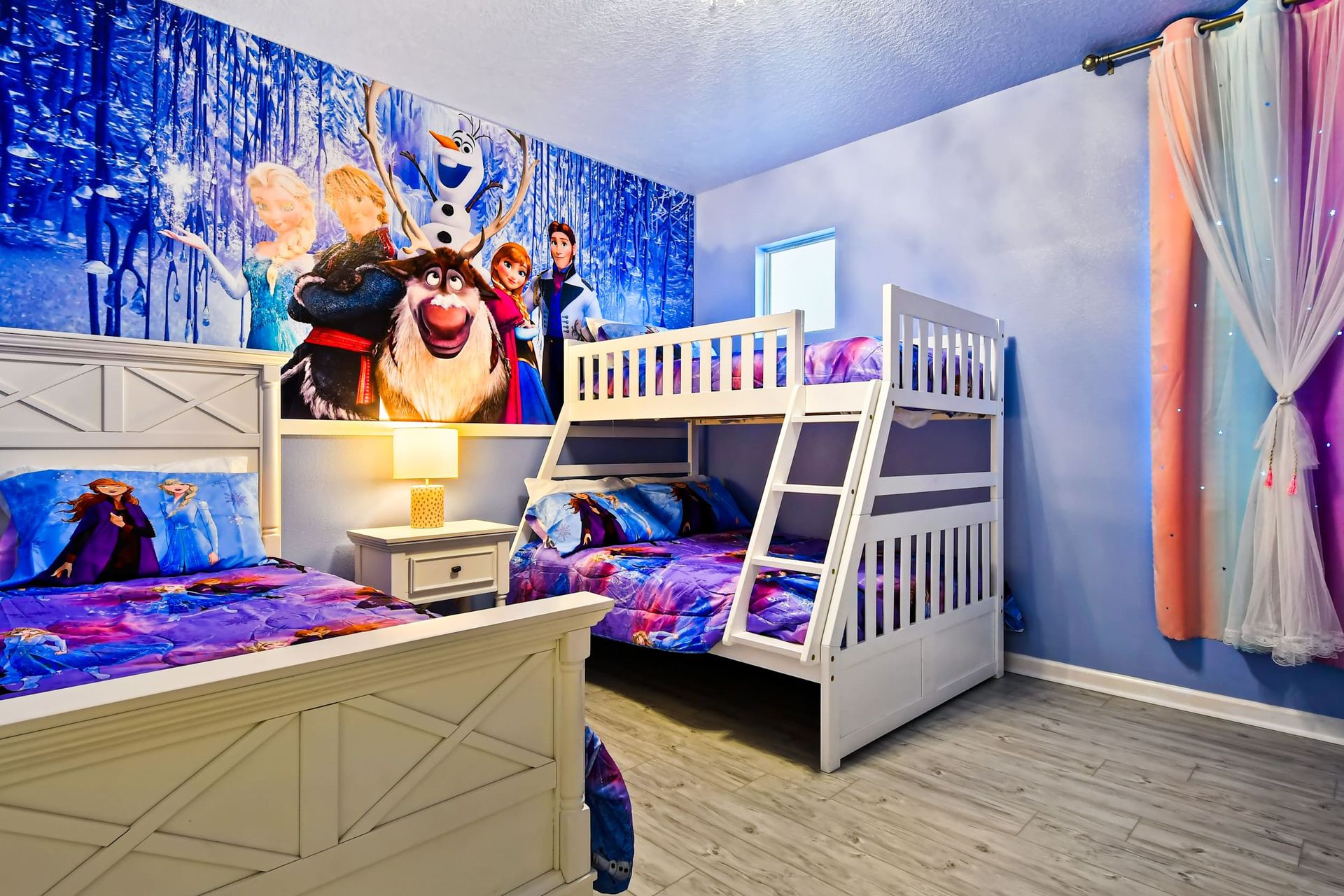 Whimsical Frozen-themed bedroom with bunk beds, vibrant decor, and magical charm!