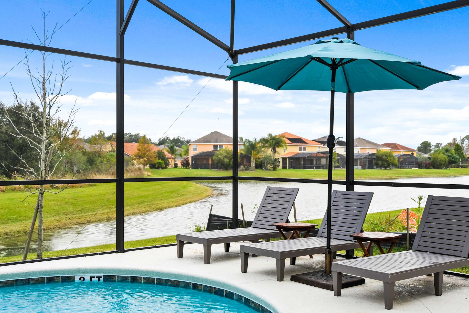 Relax by the pool with serene lake views, cozy loungers, and a screened patio oasis.