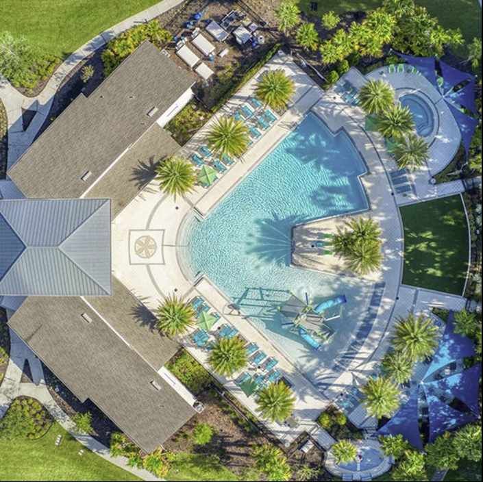 Stunning aerial view of Veranda Palms' resort-style pool, surrounded by lush palms.