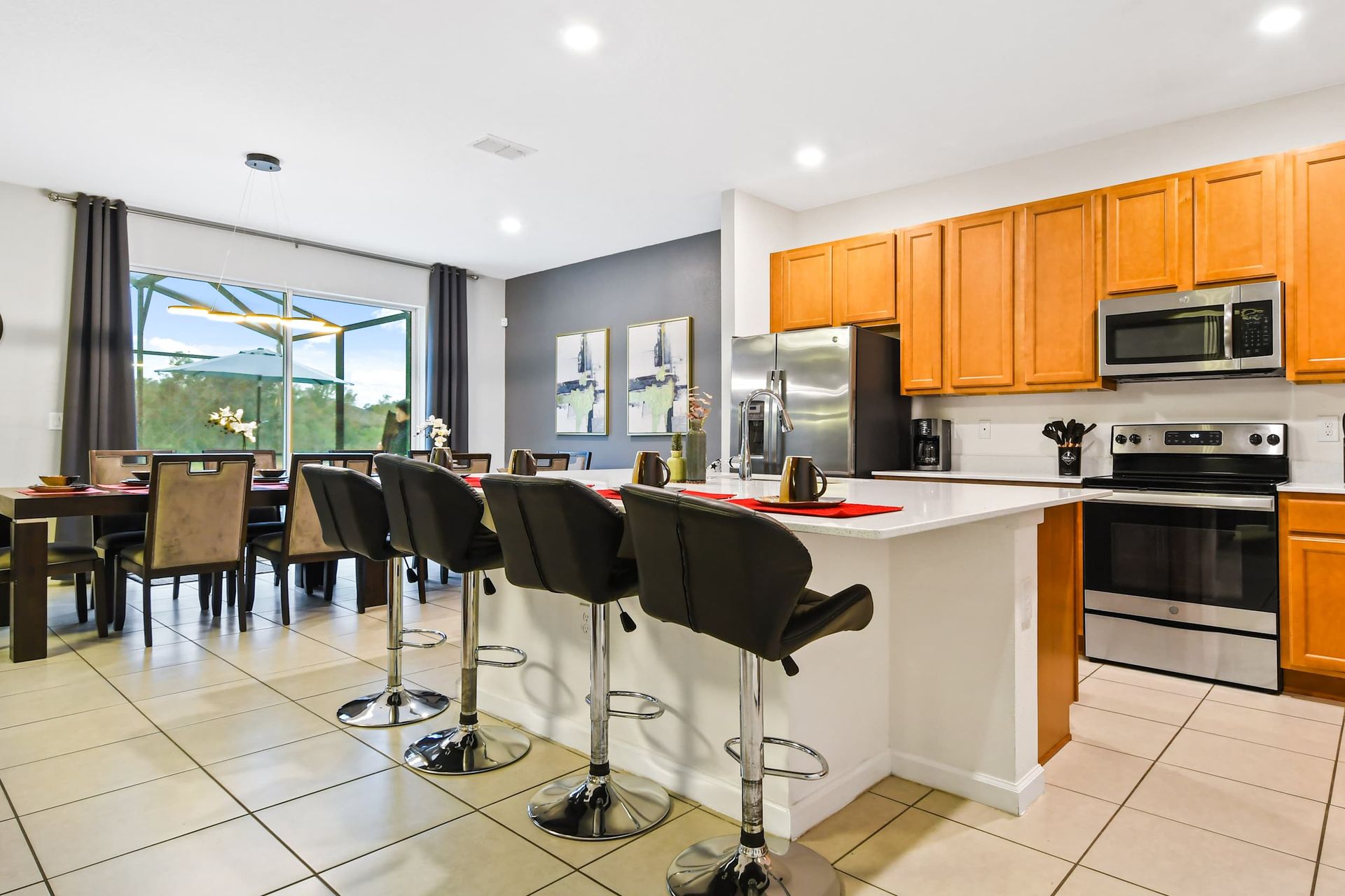 Spacious kitchen and dining area with modern appliances, bar seating, and great views.