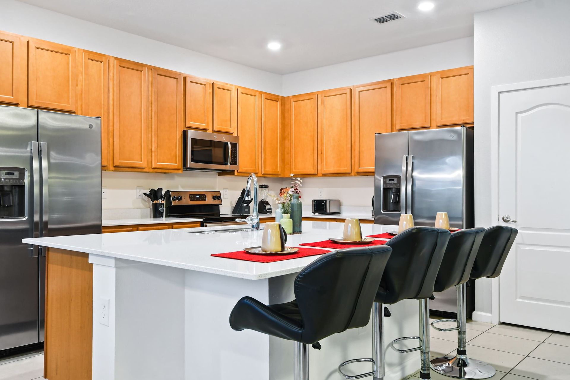 Modern kitchen with stainless steel appliances, island seating, and sleek design.