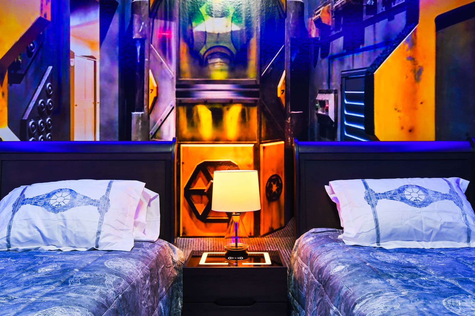 Futuristic-themed bedroom with glowing accents, twin beds, and intergalactic vibes!