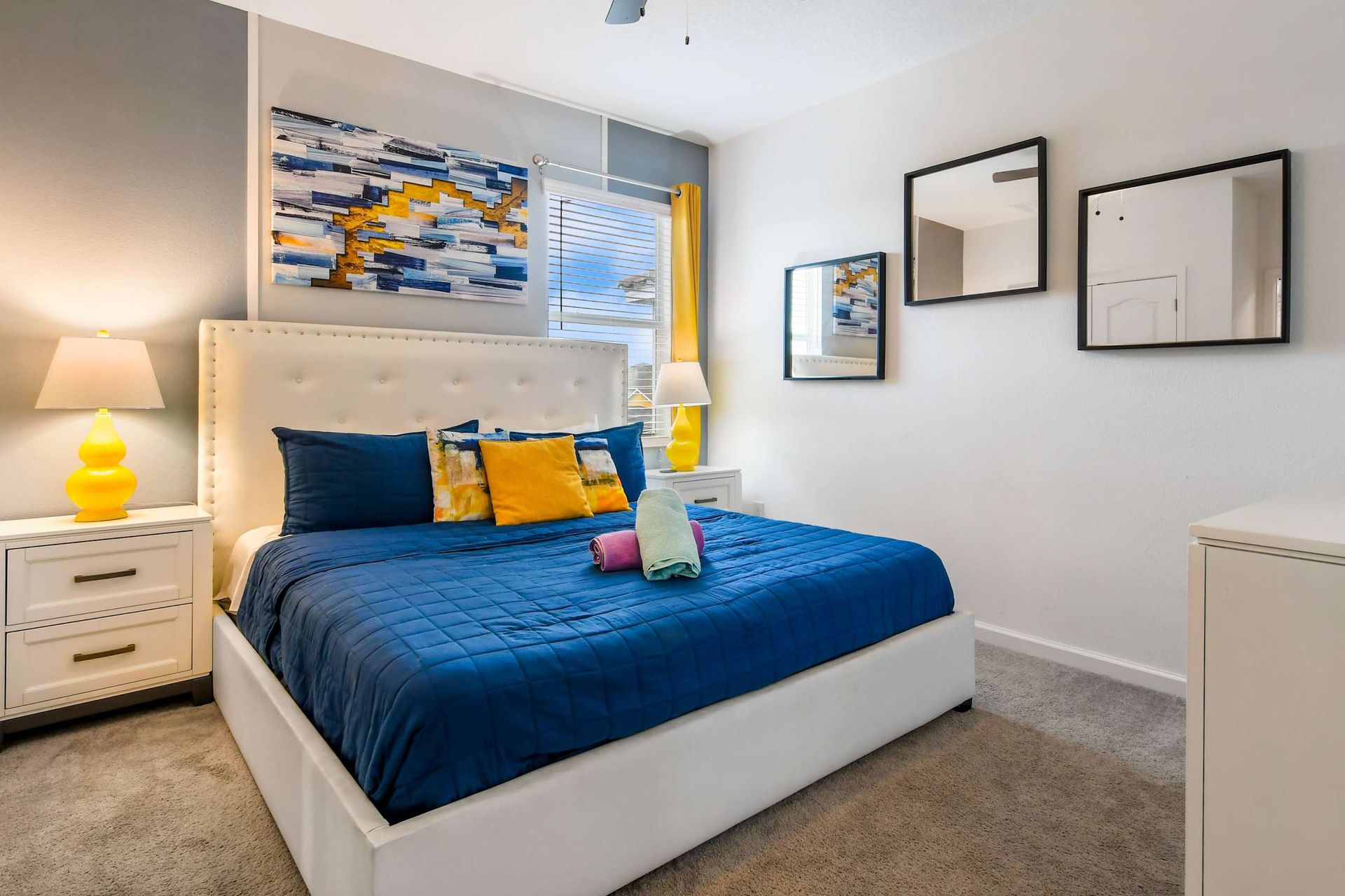 Chic and cozy bedroom with a plush bed, modern decor, and vibrant accent colors.