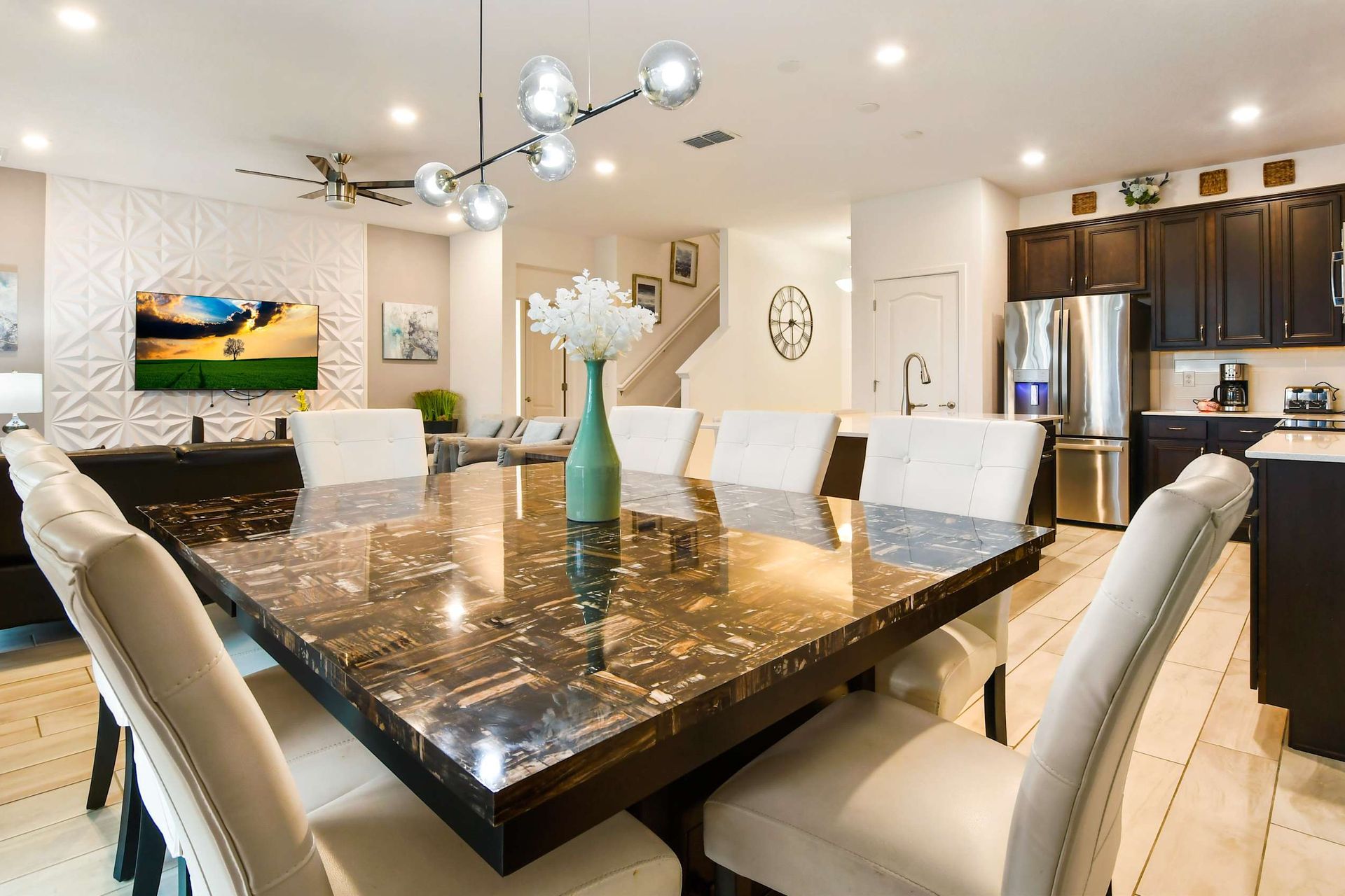 Stylish open-concept space with a sleek dining area, modern kitchen, and cozy lounge.