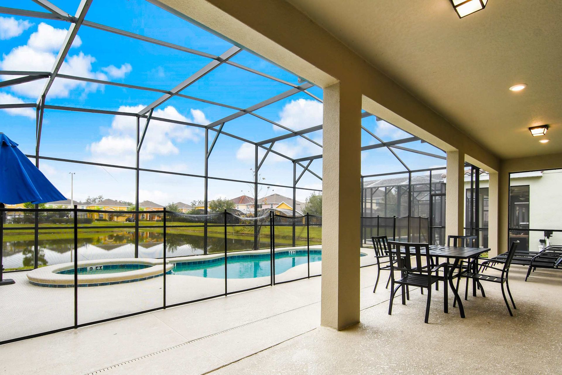 Screened-in patio with a private pool, spa, outdoor dining, and stunning lake views.