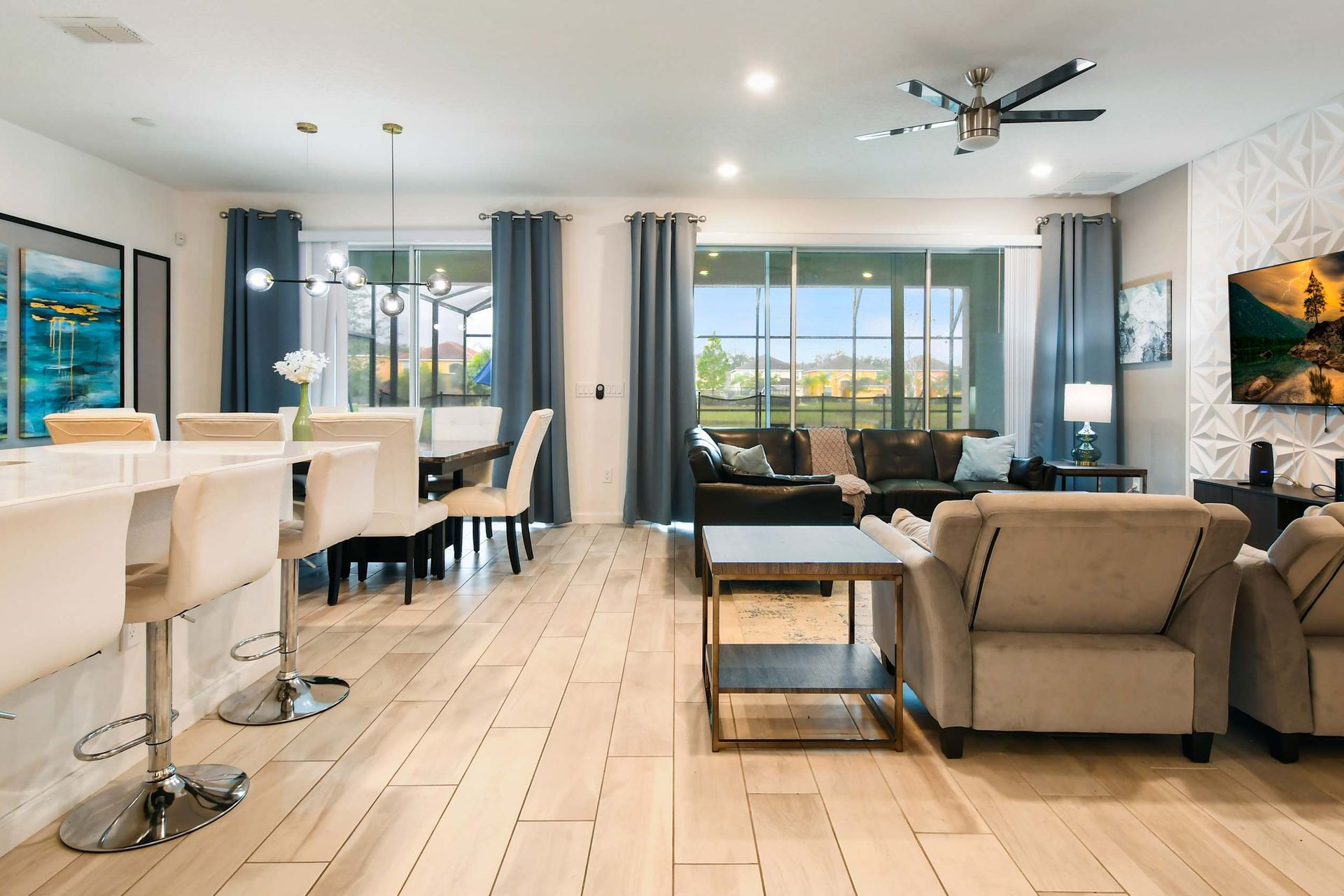 Luxury open-concept living with modern decor, a sleek kitchen, and cozy seating areas.