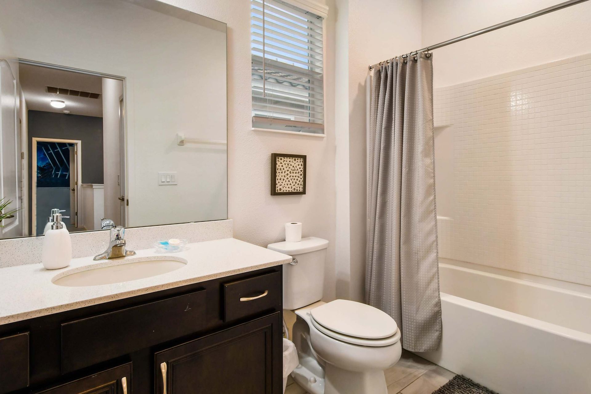 Bright coastal-themed bathroom with a tub, perfect for a relaxing getaway!