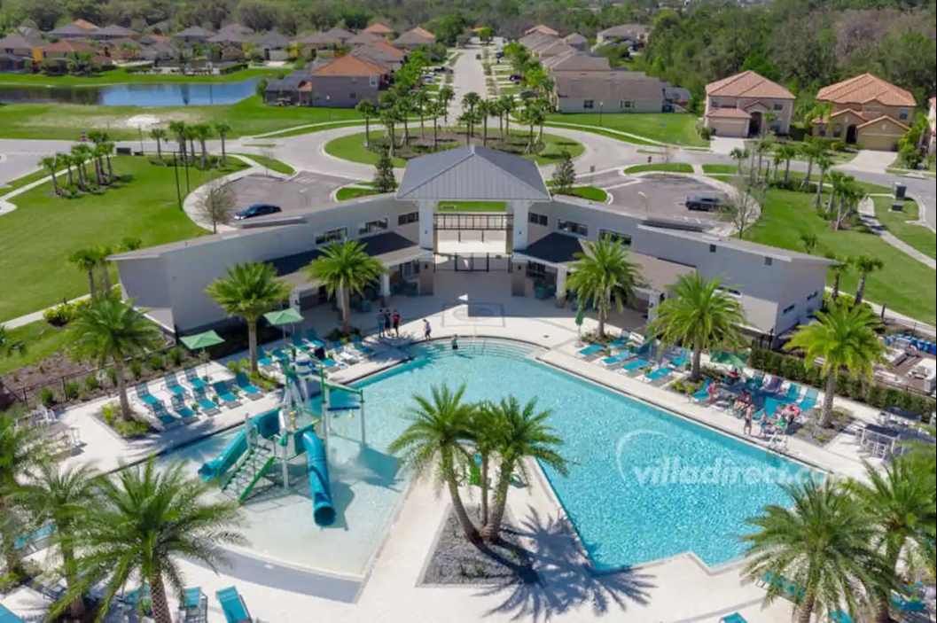 Resort-style escape with a sparkling pool, waterslides, and lush tropical views