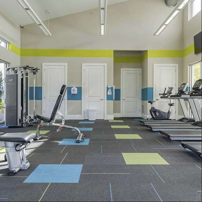 Stay fit in a modern gym with top-tier equipment, bright decor, and pool views