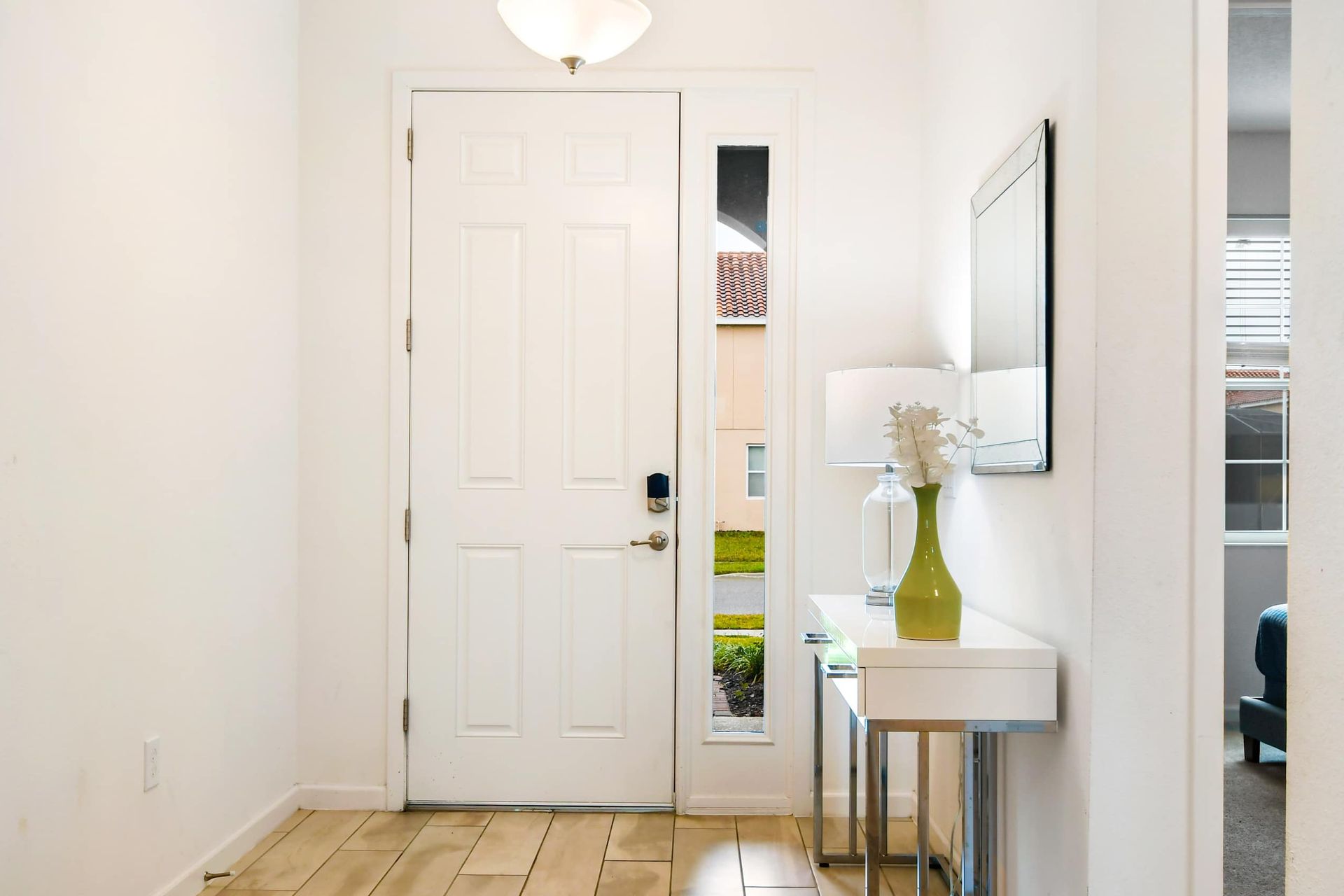 Bright and modern entryway with sleek decor, a stylish console table, and warm lighting.