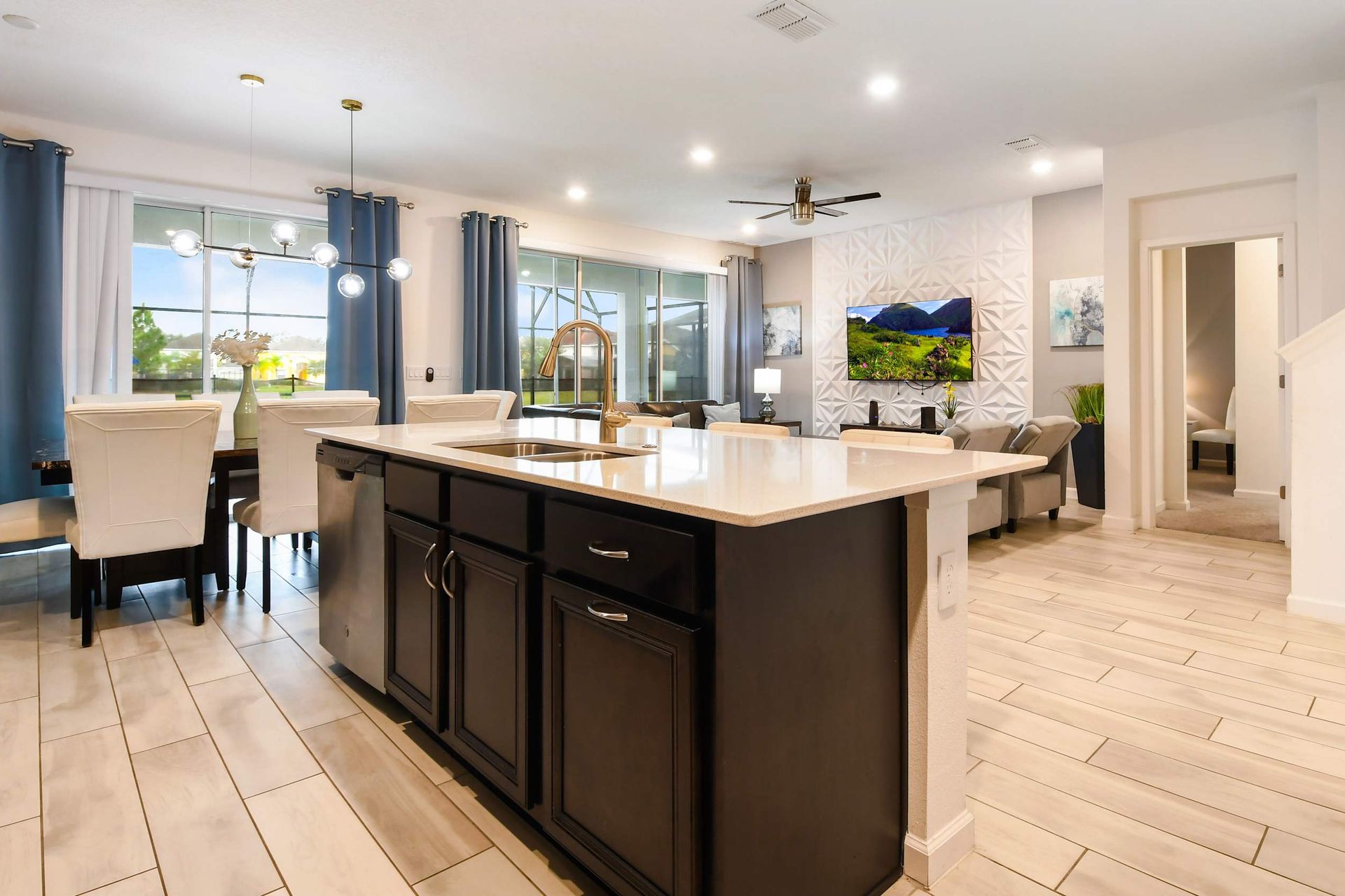 Modern open-concept kitchen with sleek finishes, elegant dining, and a cozy living area.