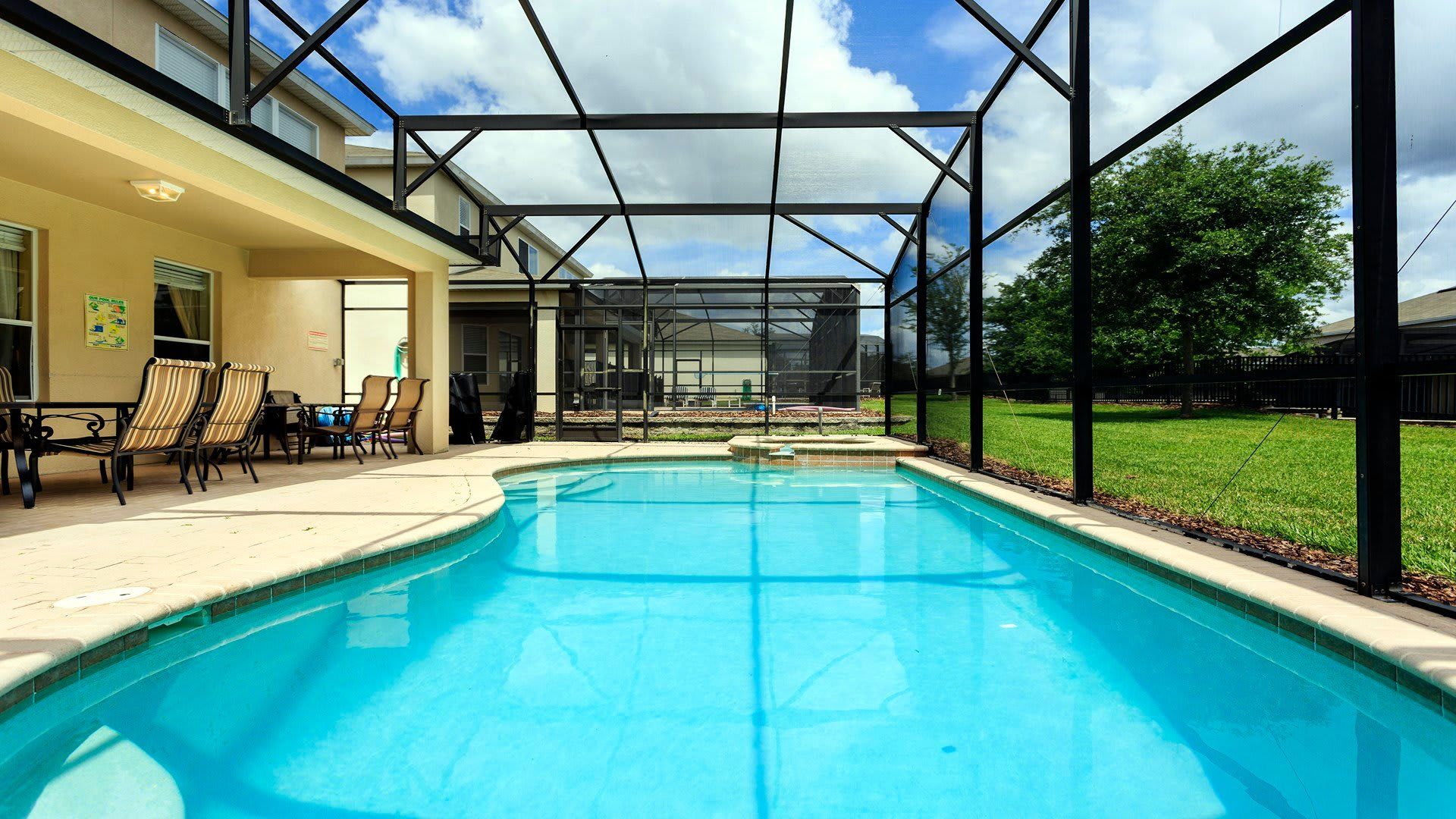 Private screened-in pool and spa with lounge chairs, outdoor dining, and sunny vibes!