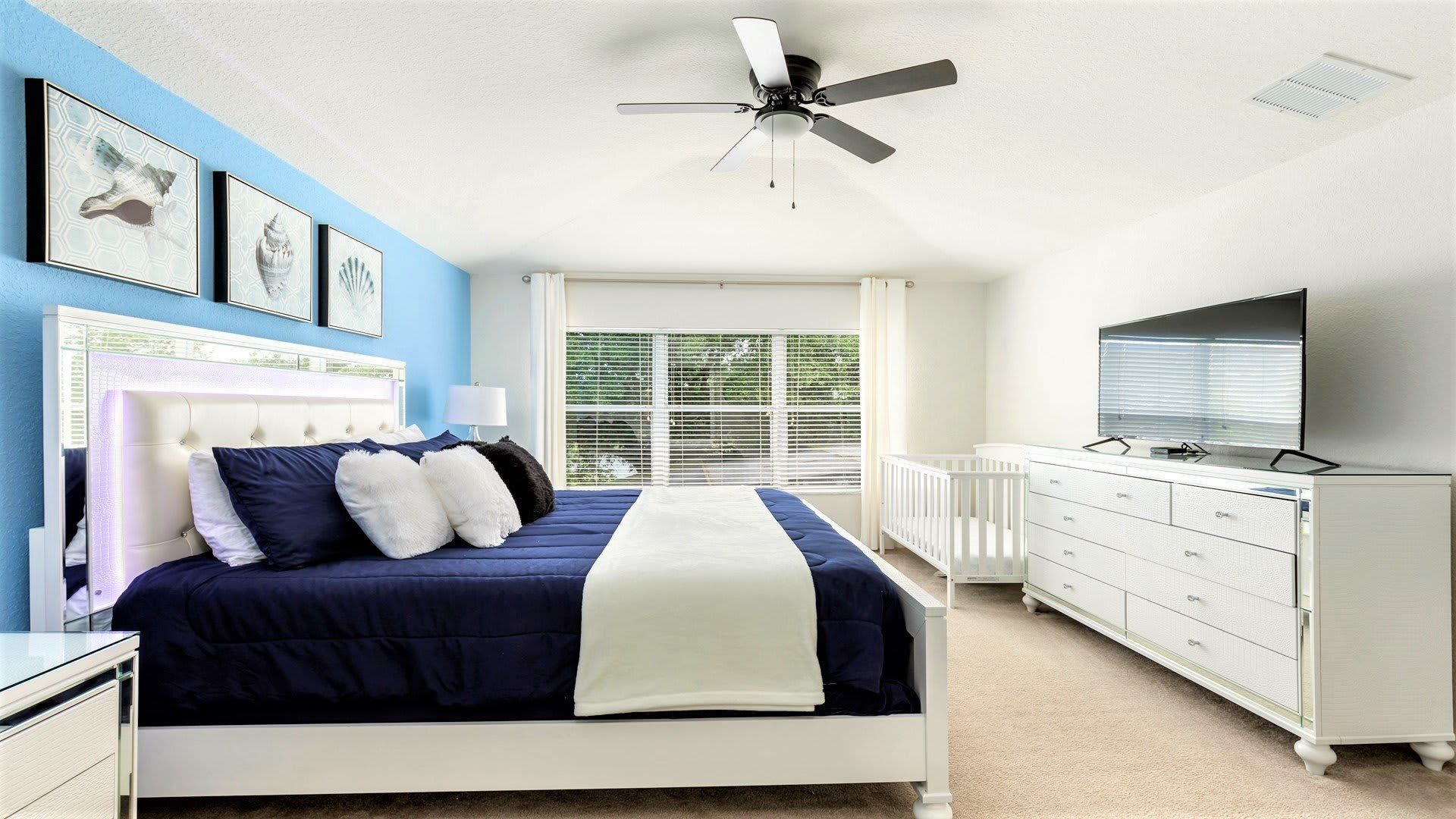 The master bedroom on the ground floor with a luxuriously large king bed