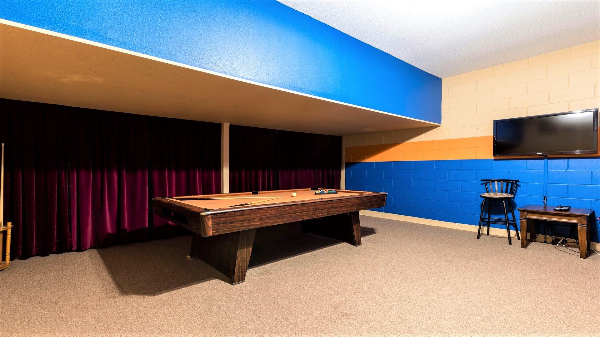 Fun game room with a pool table, TV, and cozy lounge space for entertainment.
