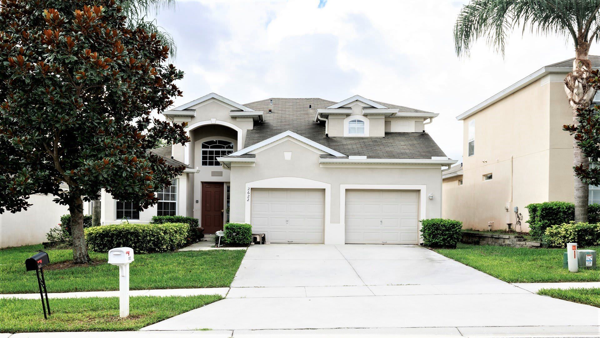 Spacious modern home with lush landscaping, a two-car garage, and great curb appeal.